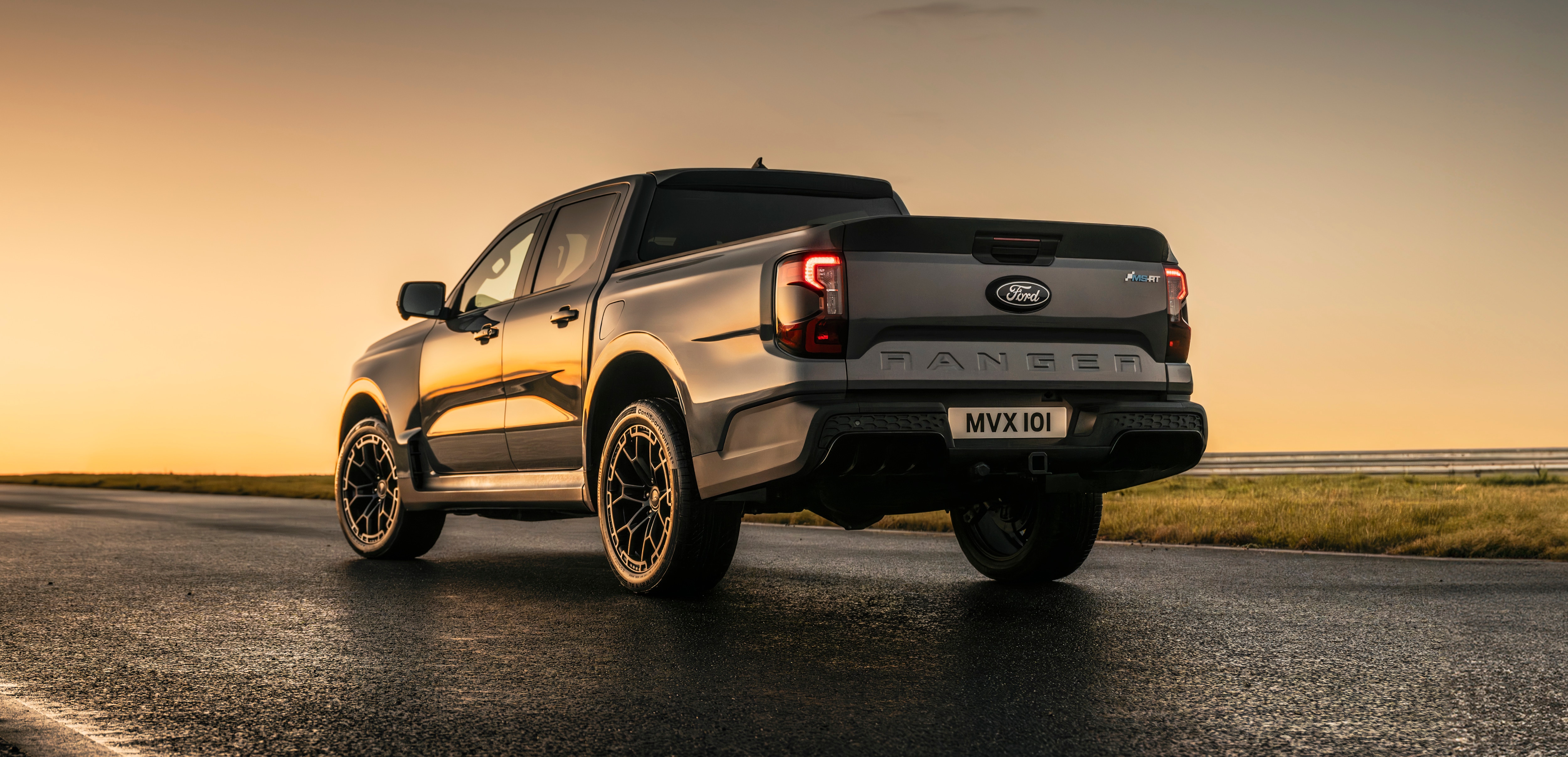 A grey pickup at sunset