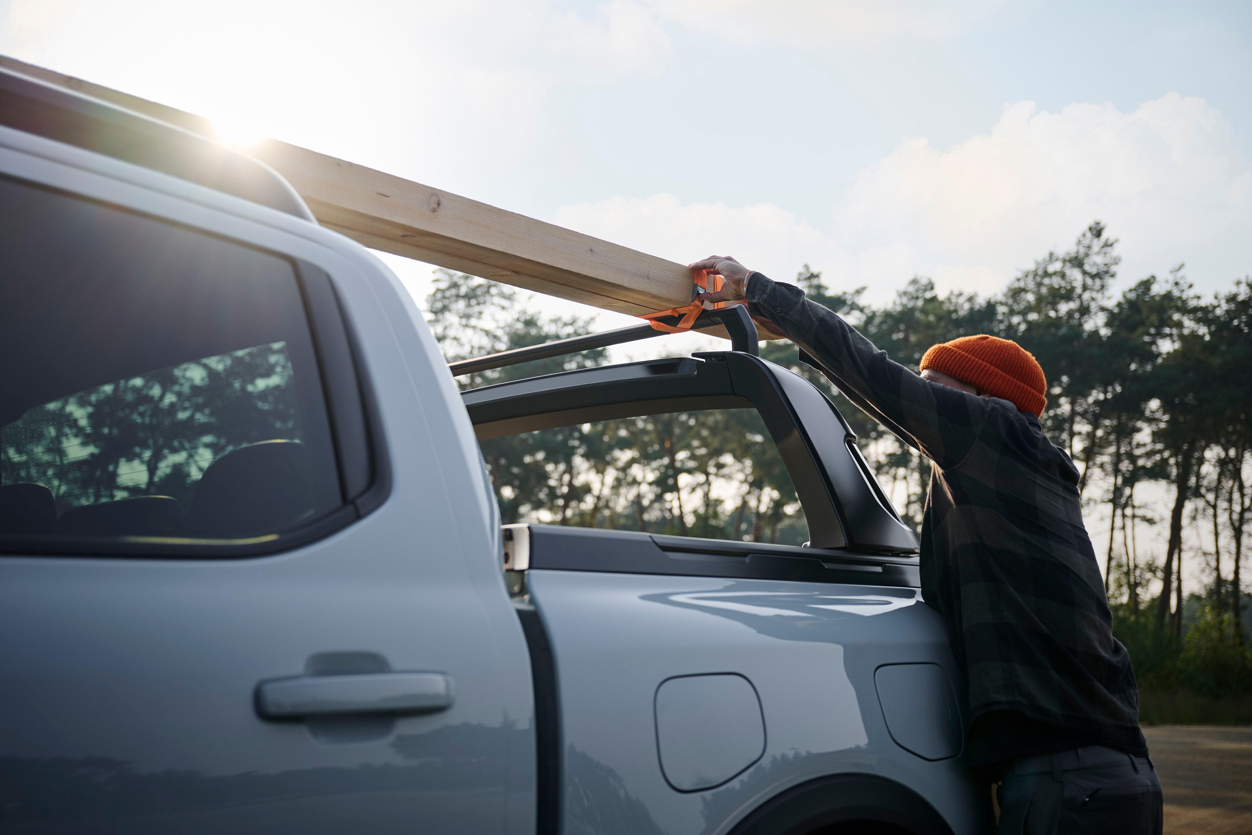 A man loading wood onto his truck