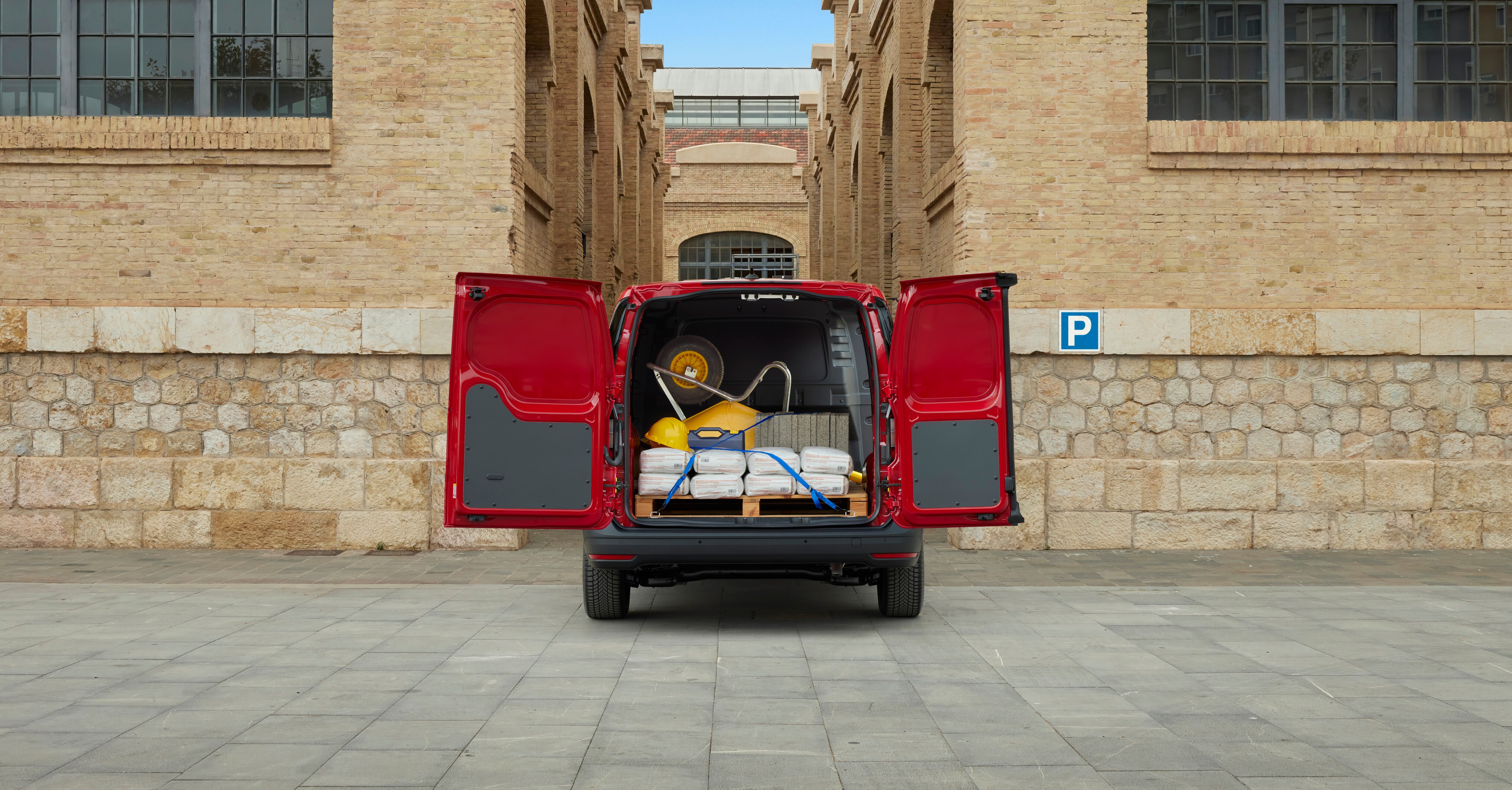 a red van full of equipment with open doors