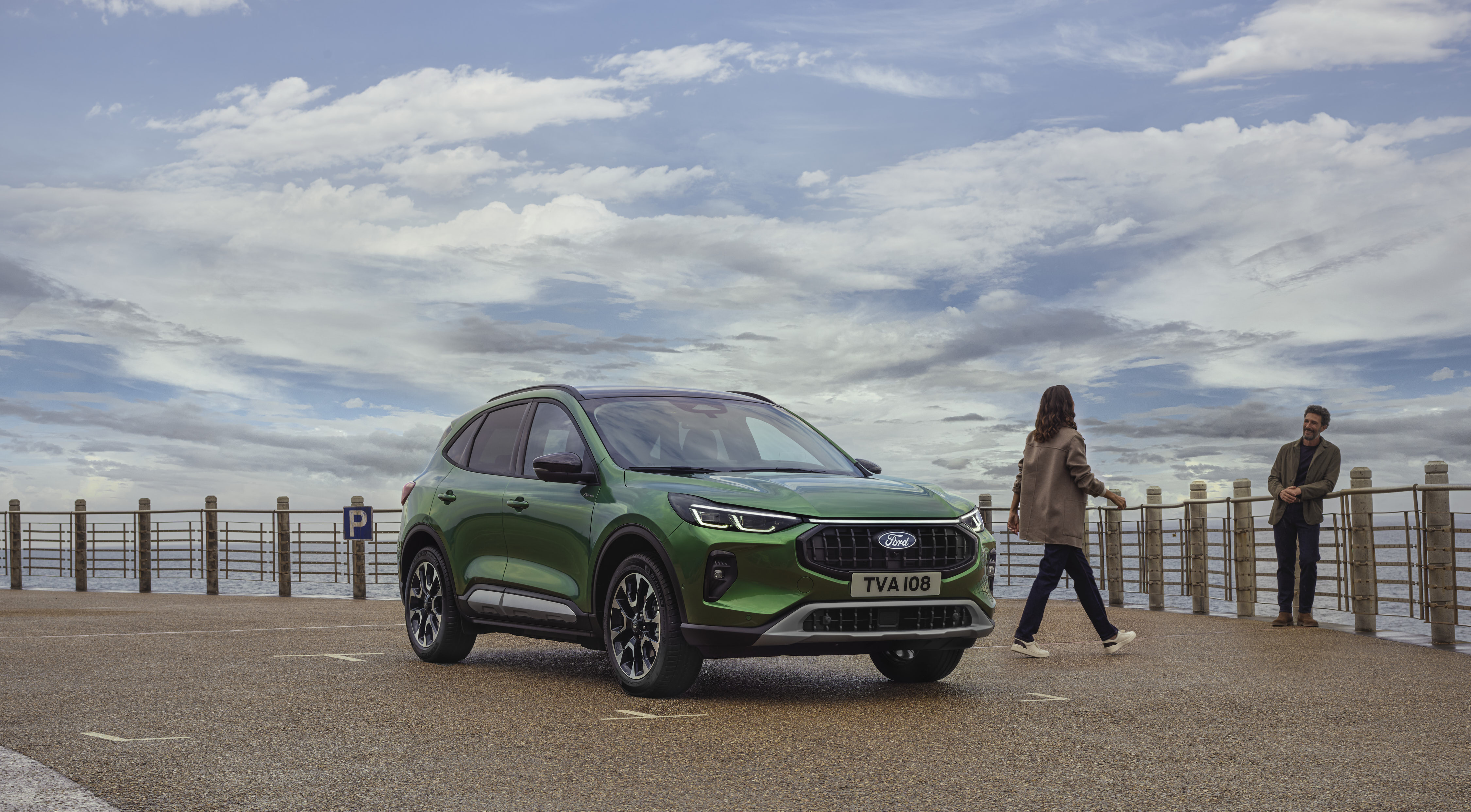 a green car by the pier