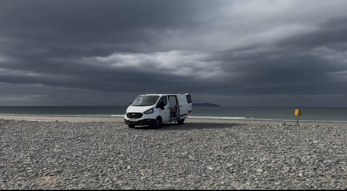 Dom Wright's modified Transit home on a beach.