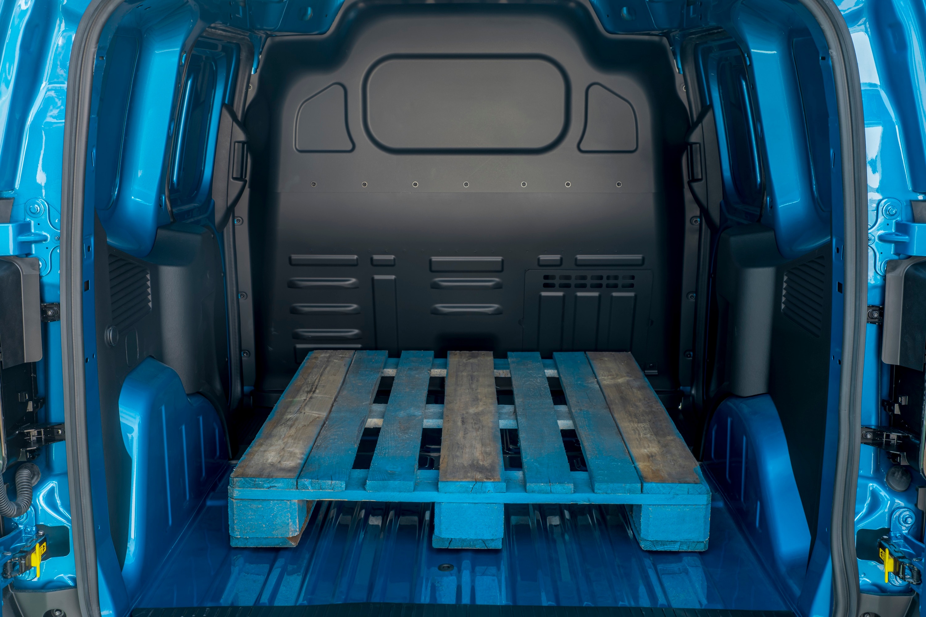Ford E-Transit Courier load area with an empty pallet loaded