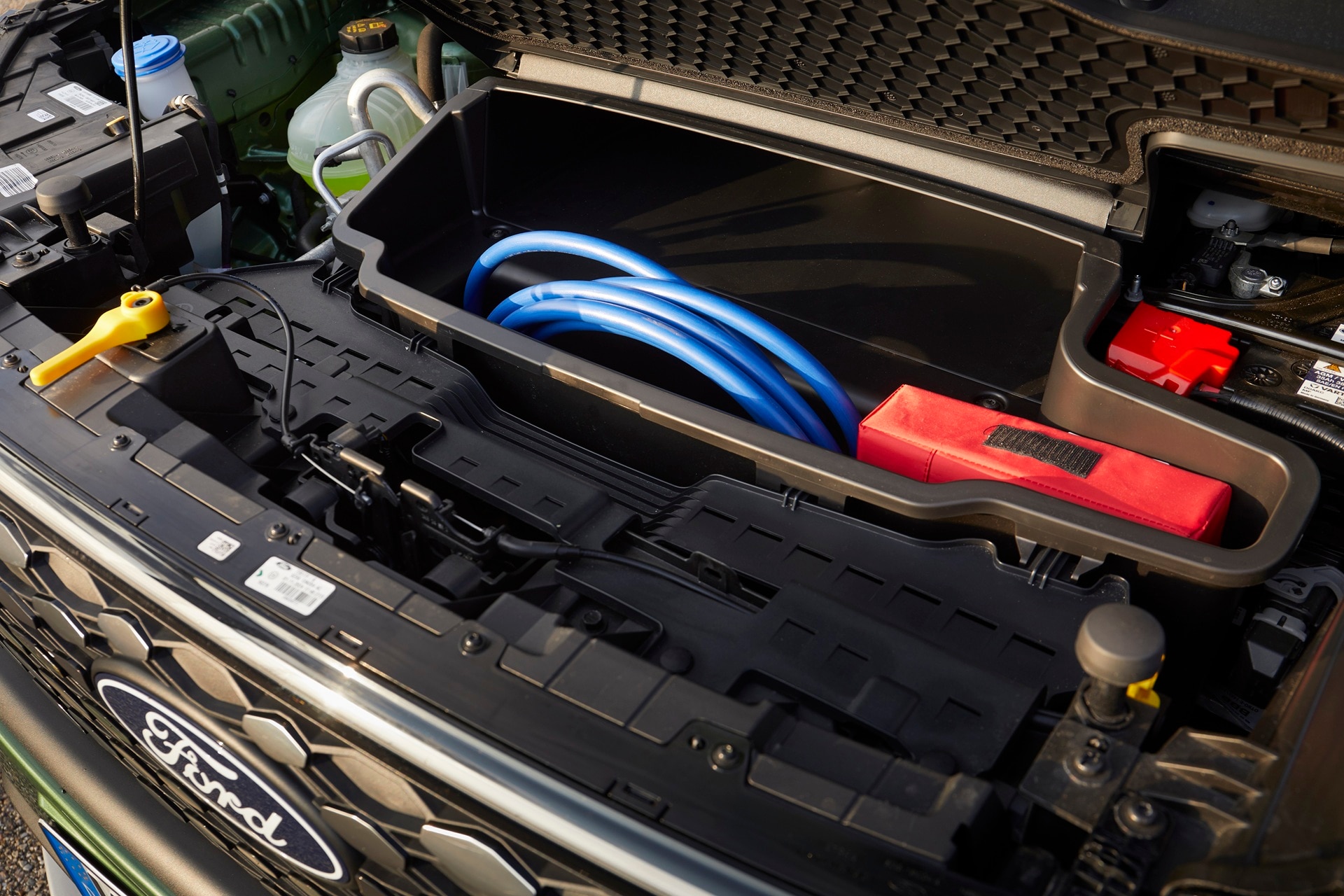 Frunk area of Ford E-Tourneo Custom with charging cable stowed
