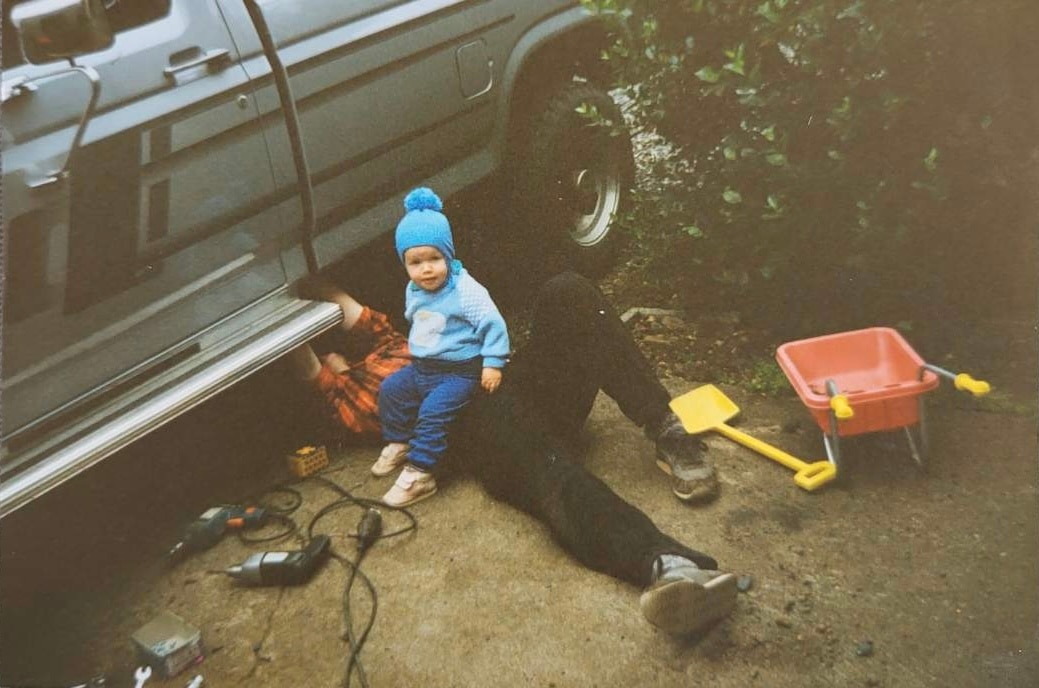 A young Siggi accompanies his father as he works on his Ford F-250.