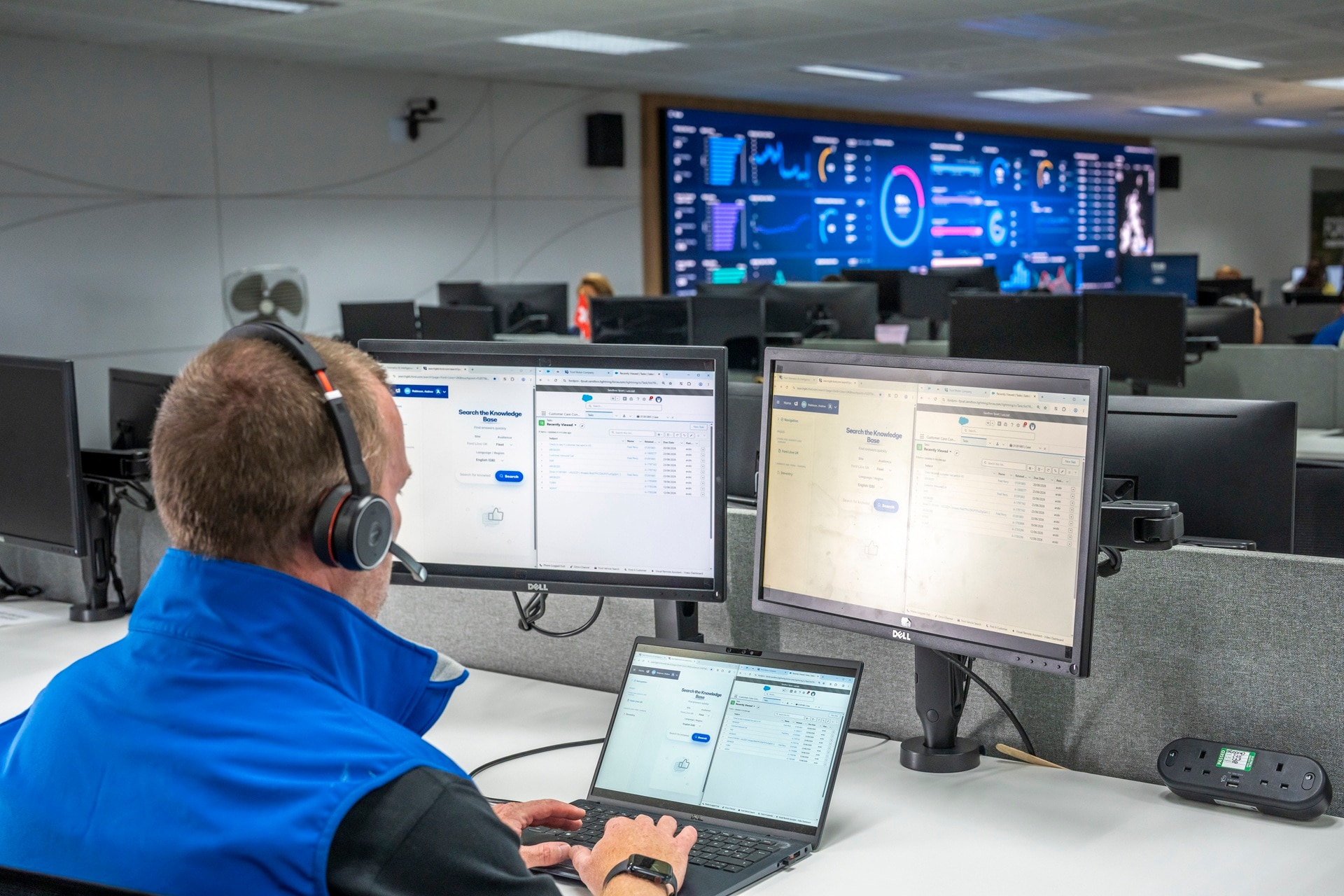 Ford Pro expert behind vehicle data tracking screens on the phone to a fleet manager