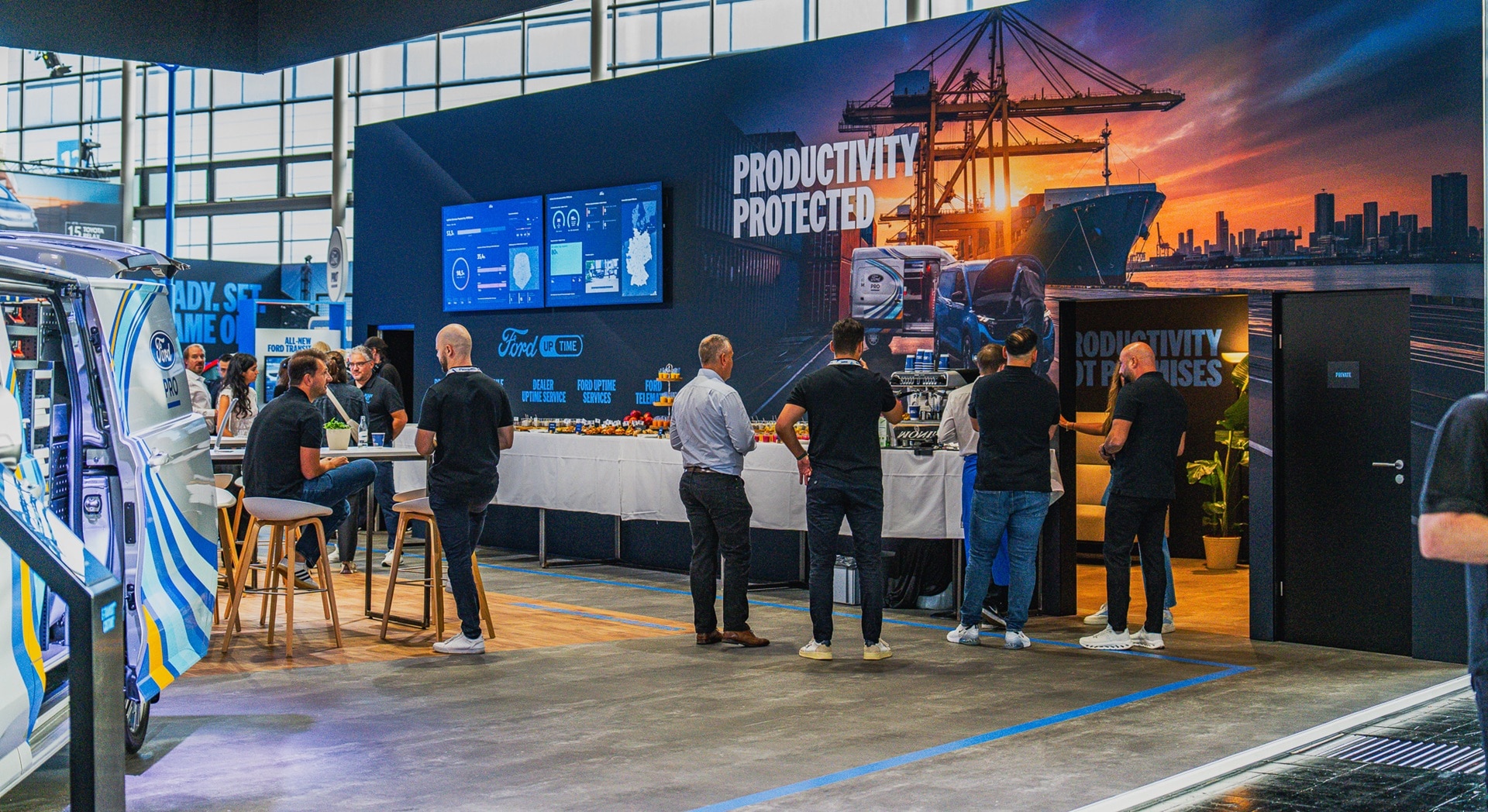 People talking near uptime screens on Ford Pro stand at IAA 2026
