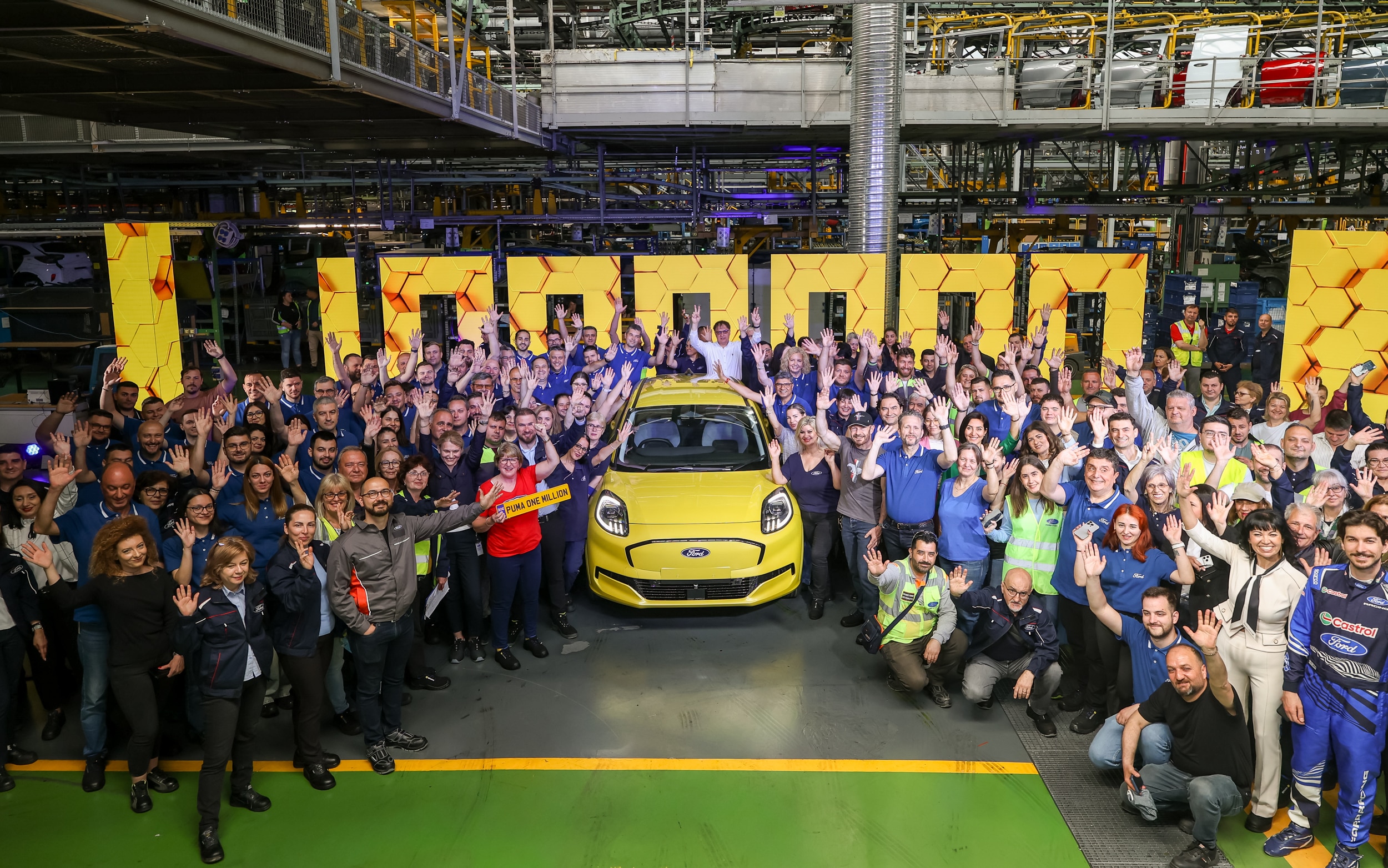 Karen celebrates with employees at the Ford Otosan plant, Craiova, Romania, after watching her Puma Gen-E roll off the production line.