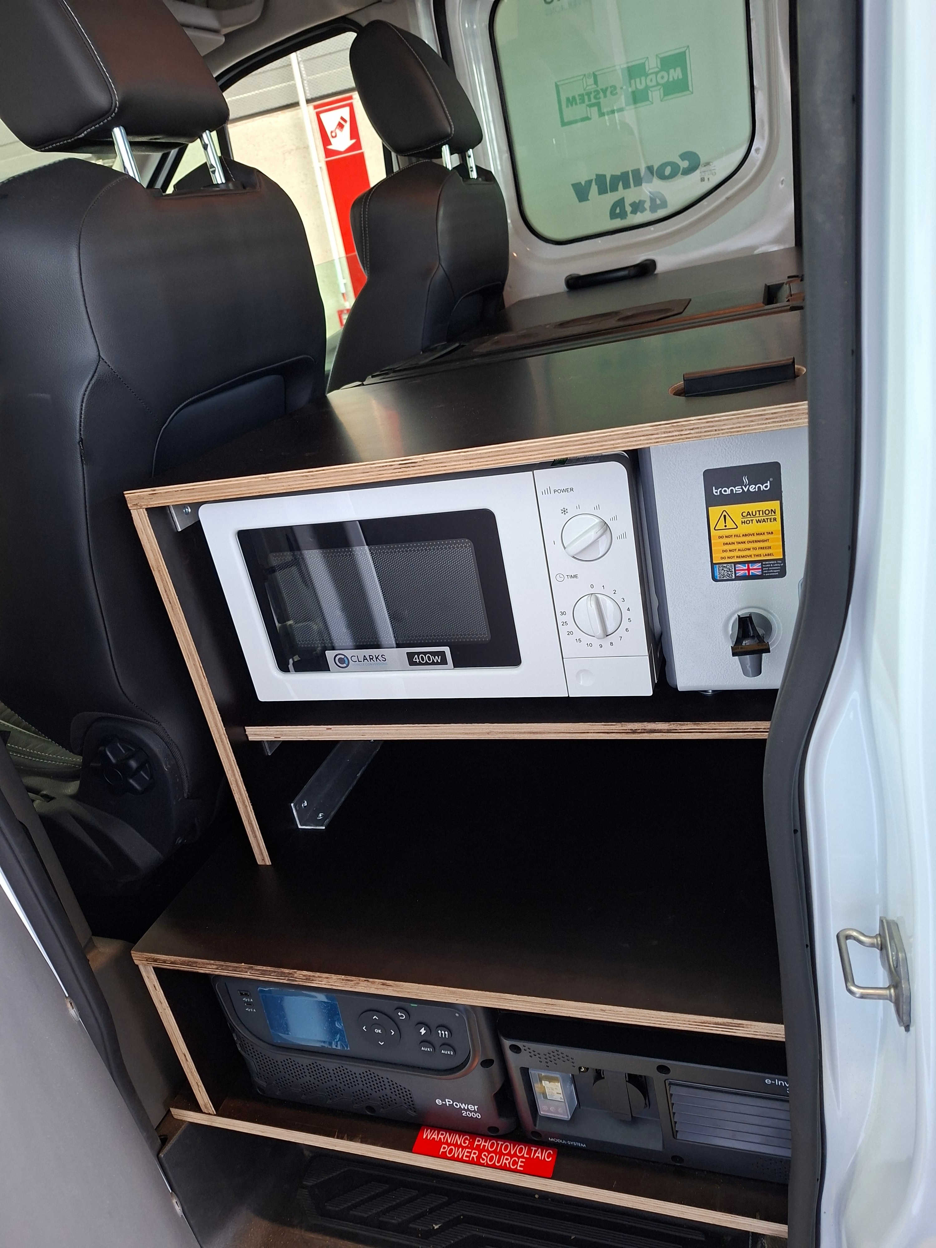 Microwave, inverter and water boiler fitted where the rear seats would be