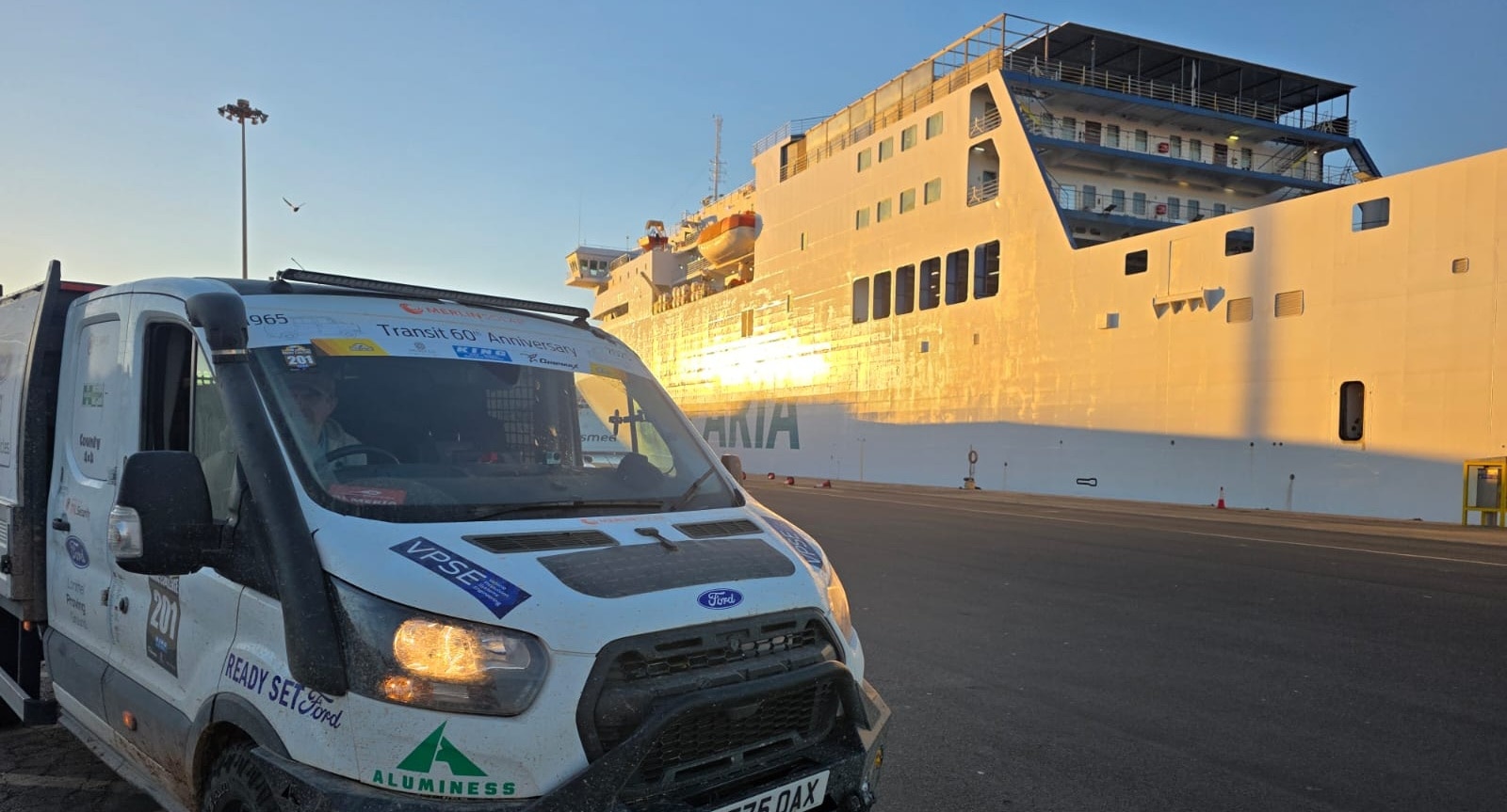 Maroc Challenge Transit parked by large ferry at the dockside