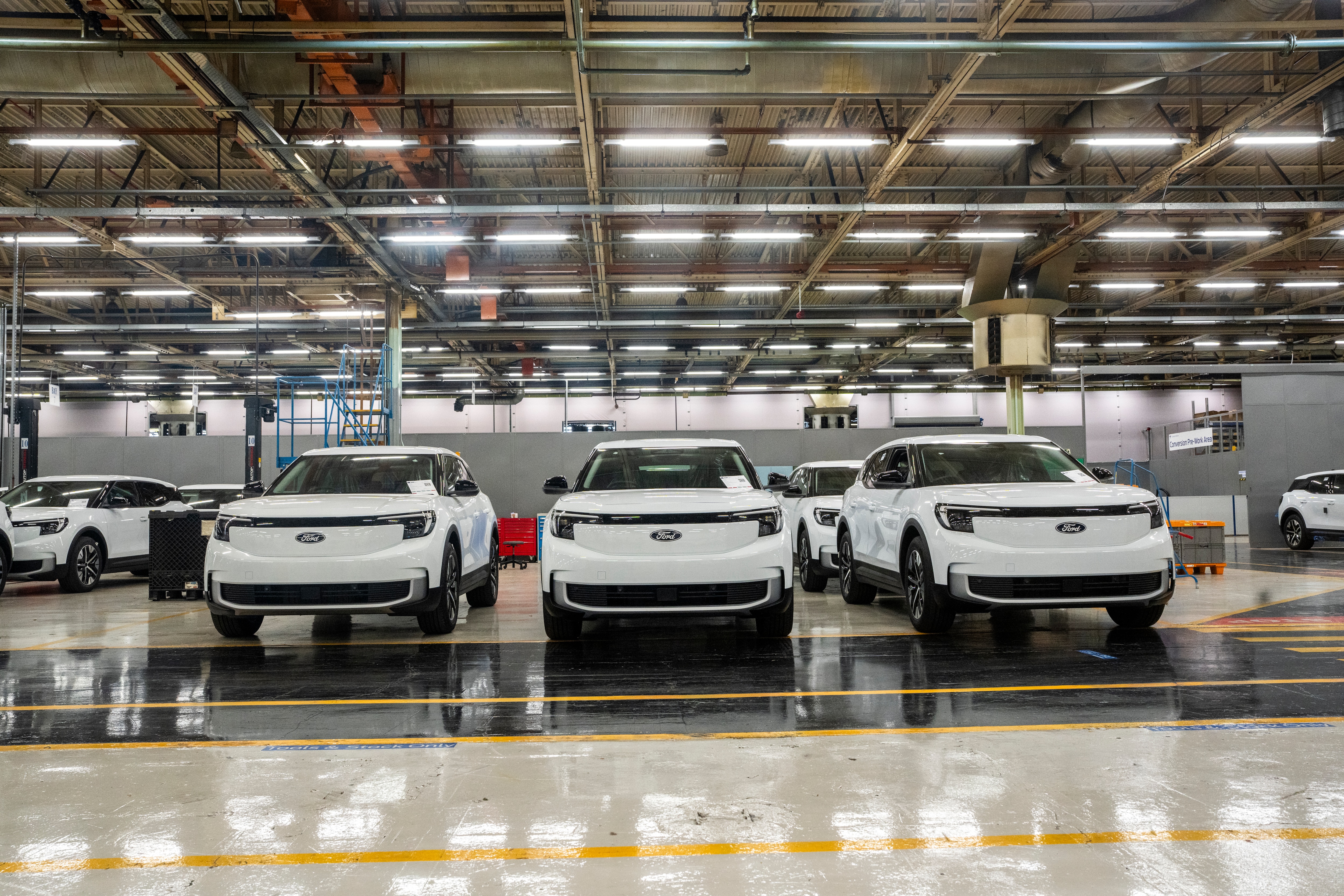 Just some of the Ford Explorers waiting to be turned into robust vans for businesses expanding their electric fleets