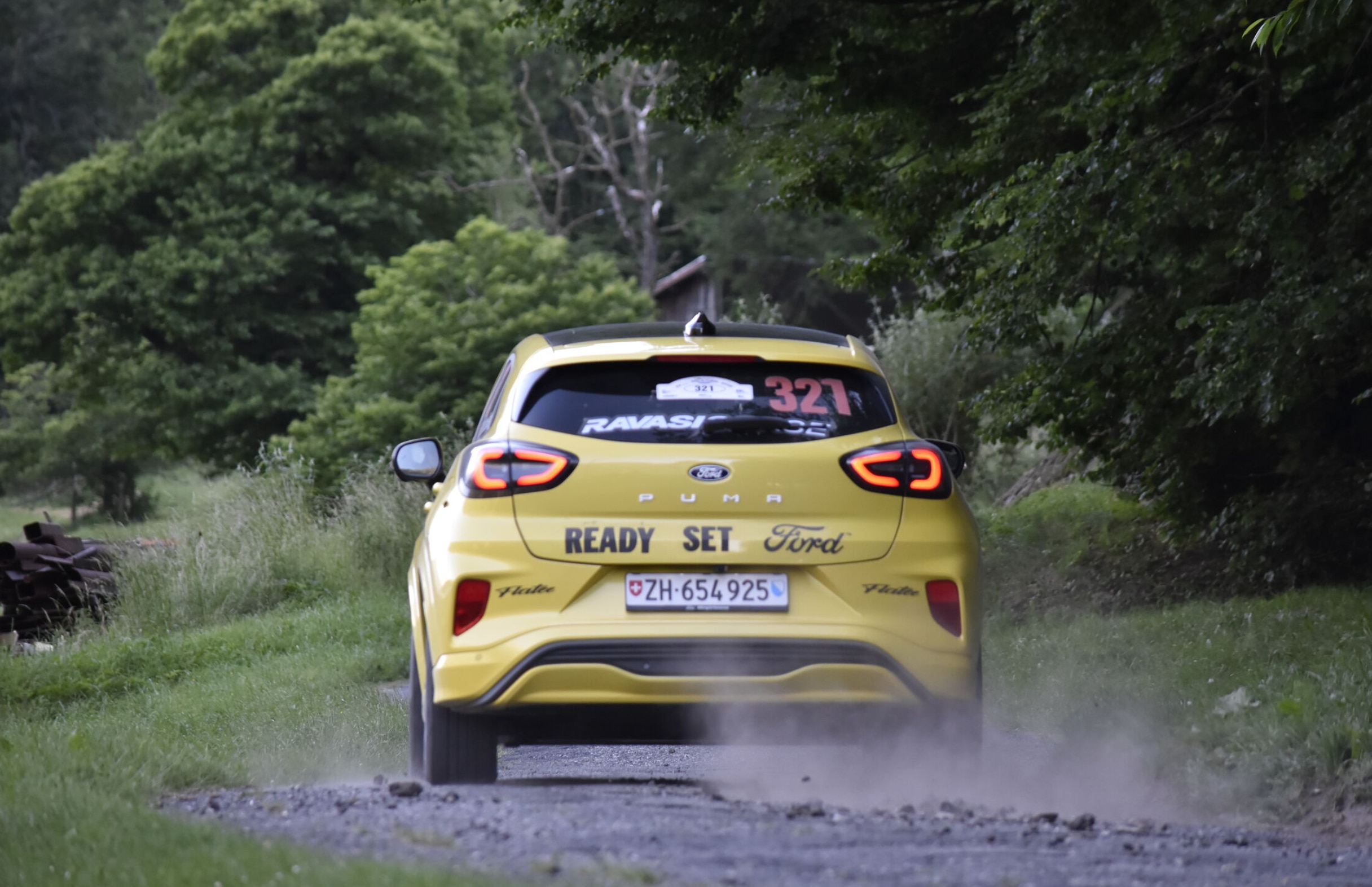 The Puma Gen-E, tearing down a dirt road on one of the Rallye du Chablais special stages.