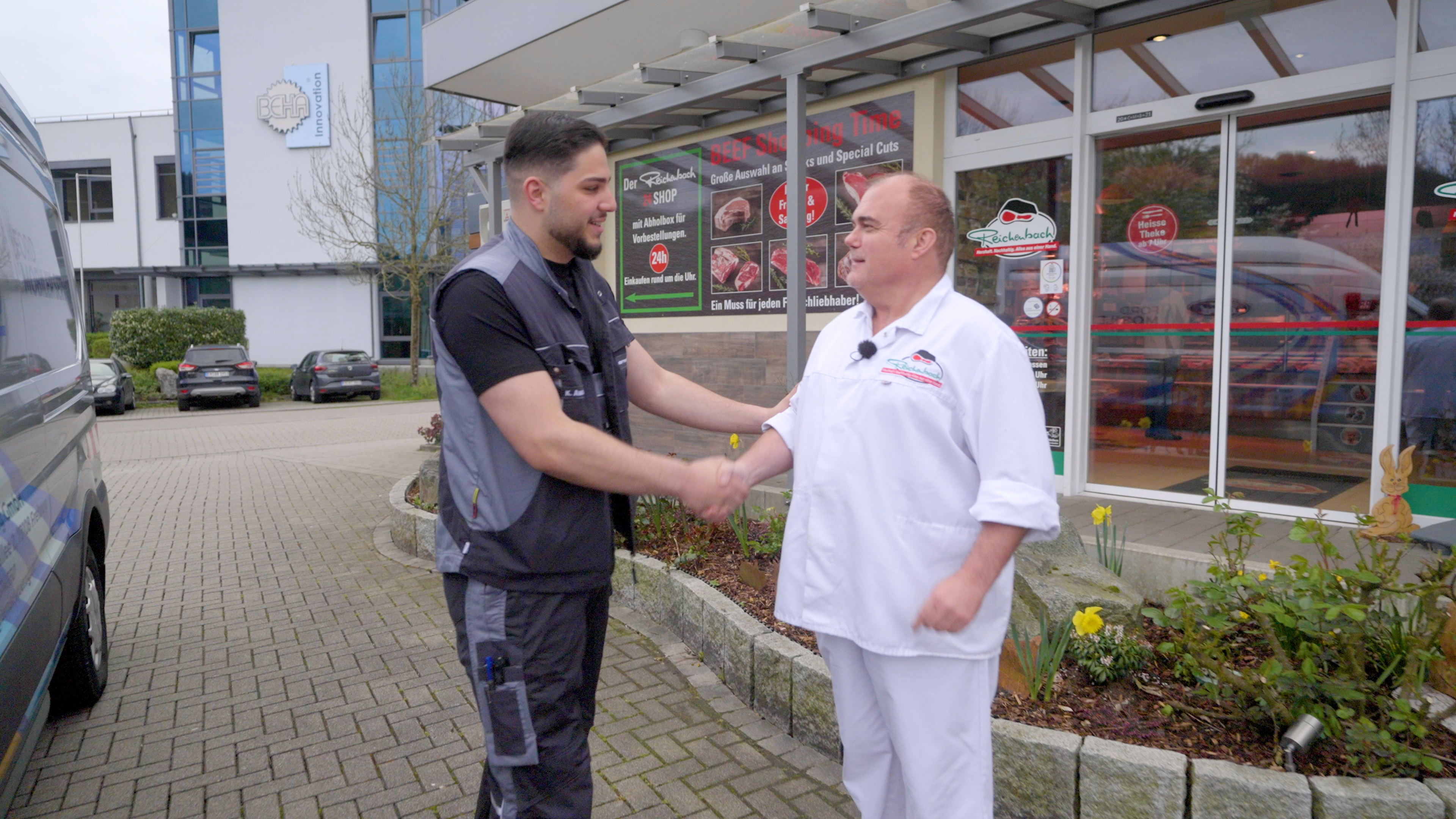 Ford technician from Ernst and König greeting Ulrich at Metzgerei Reichenbach