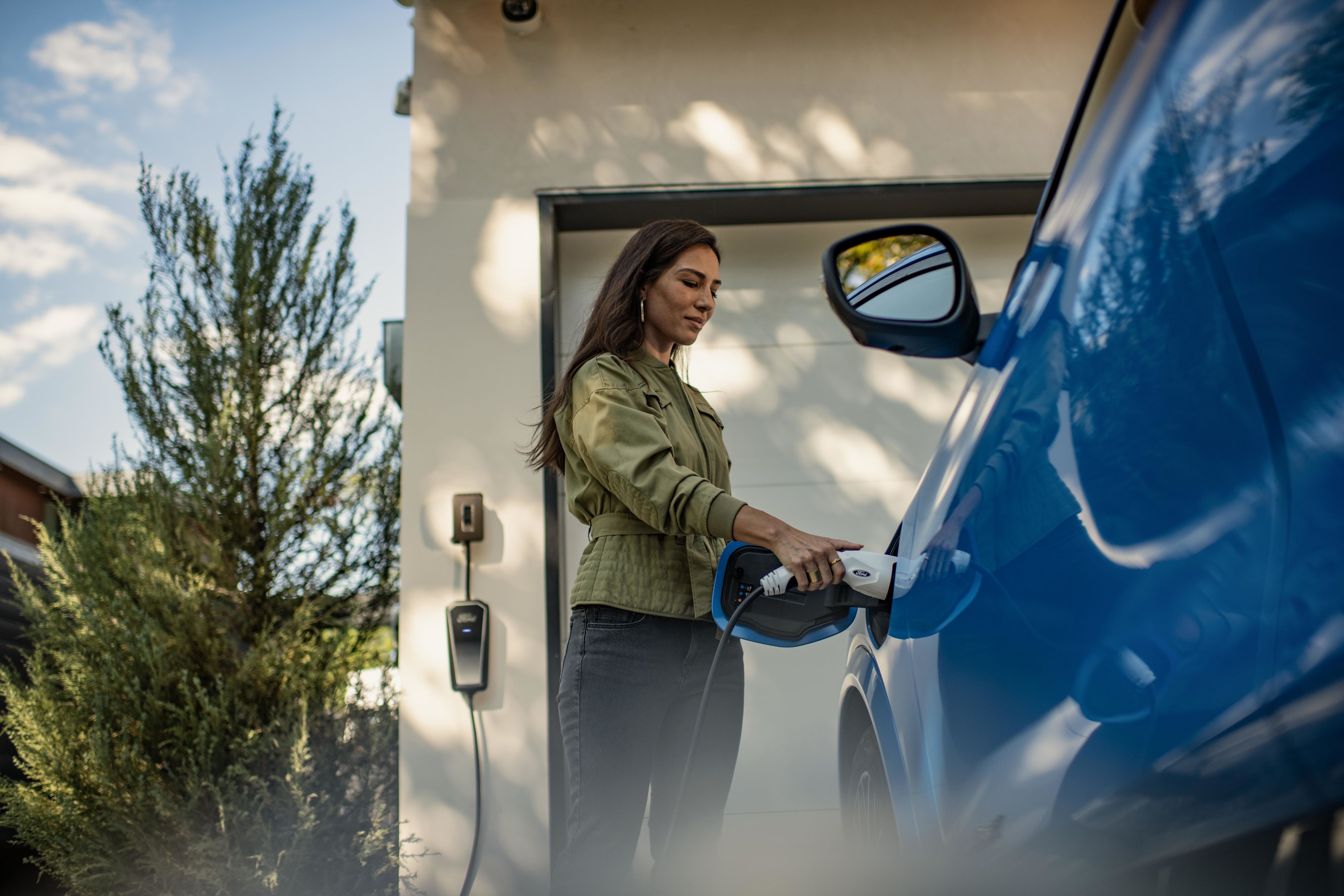 A customer charges an electric Ford Mustang Mach-E at home