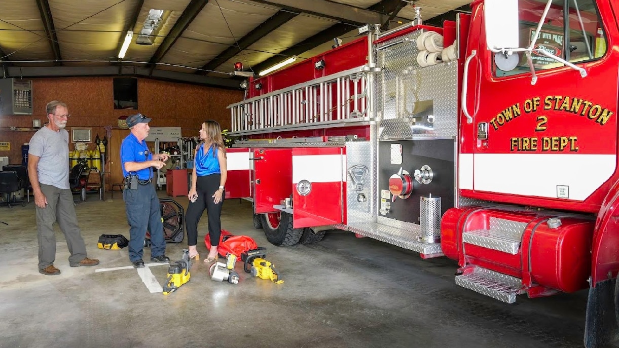 Chief Dancy with Stanton Volunteer Fire Department and Marianne Dunavant with Ford Community Relations stand among lifesaving tools purchased with the Ford Grant.
