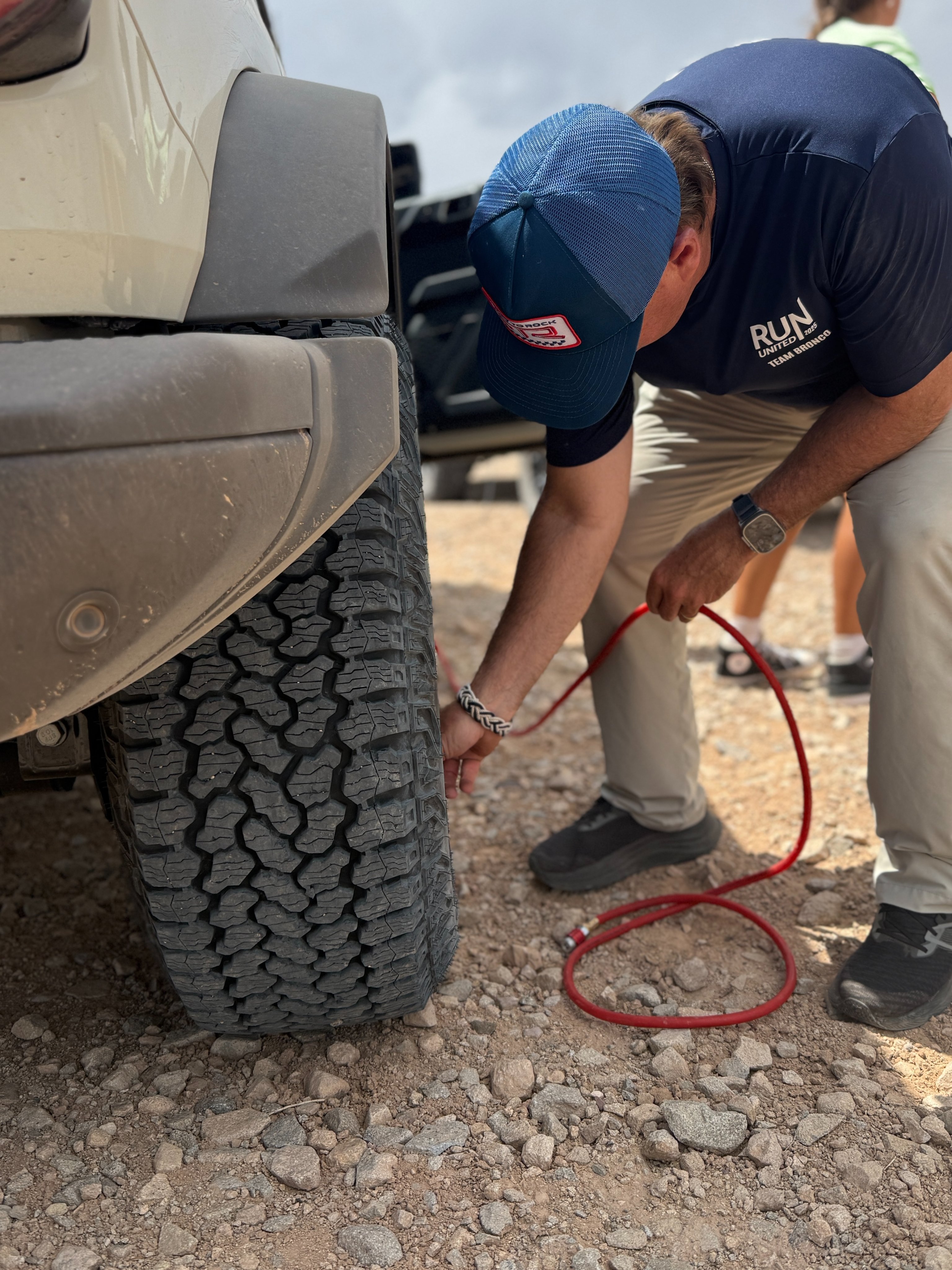 Jim airing down the tires on his Bronco before continuing the trip.