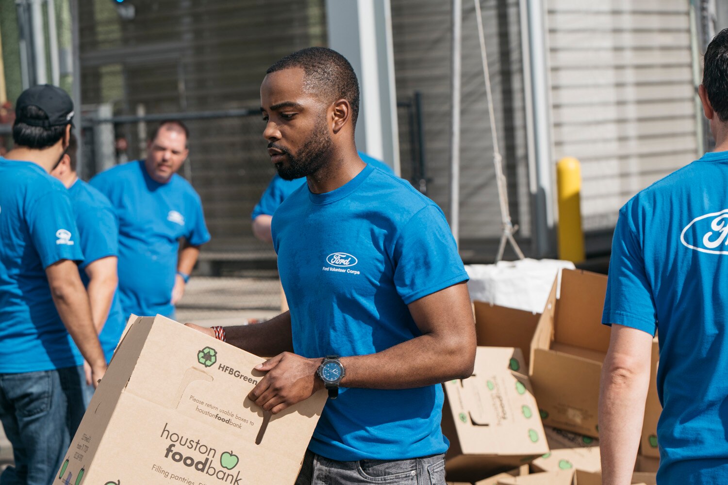 Ford employees, Houston-area Ford dealers and local nonprofits gathered at Houston Food Bank for a Texas Is Family community event that marked the donation of 38 Ford vehicles to eight organizations in the state.