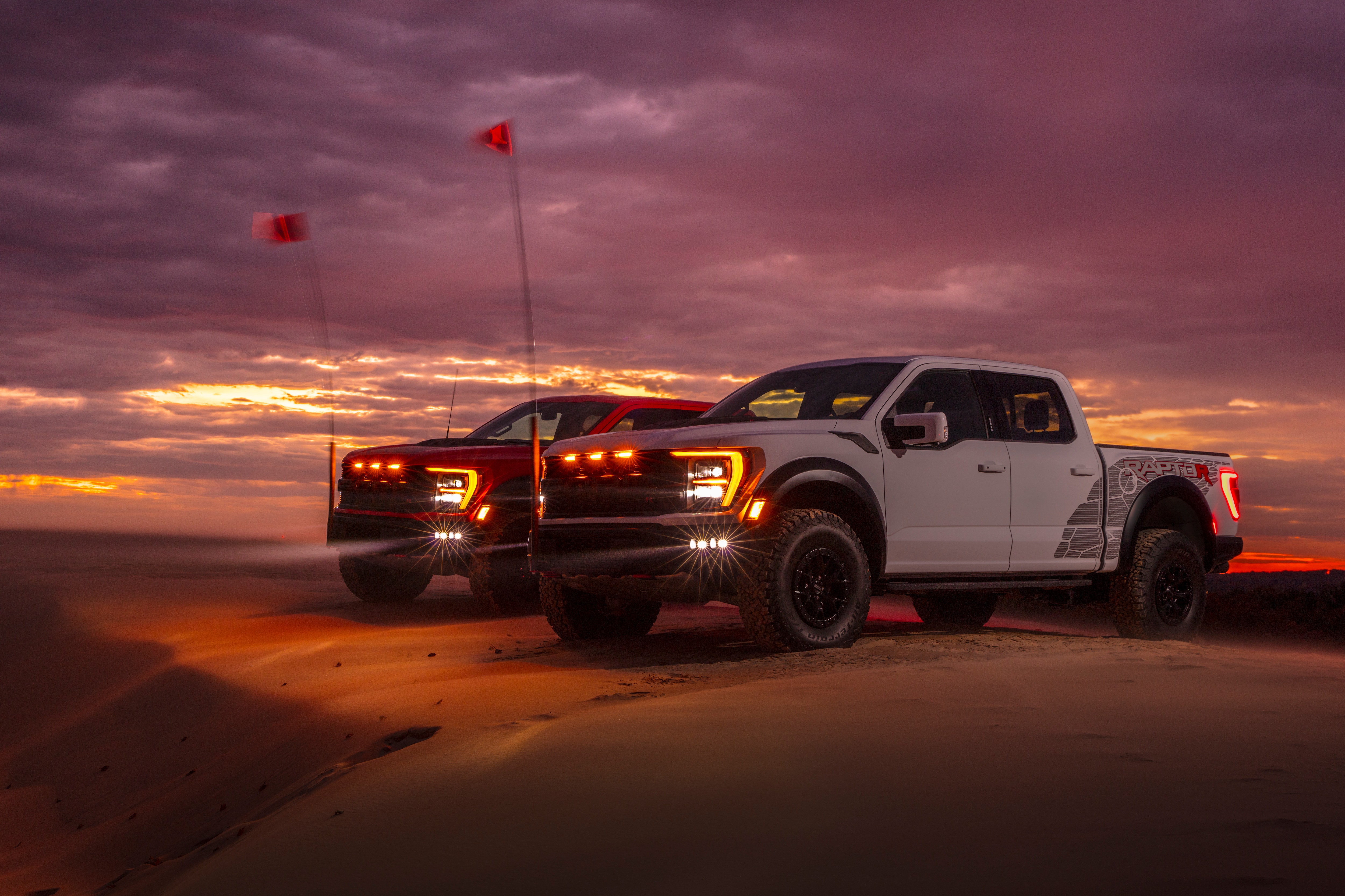 Preproduction 2023 F-150 Raptor R with aftermarket flag and optional equipment. Available late 2022. Professional driver on a closed course. Always consult the Raptor supplement to the Owner’s Manual before off-road driving, know your terrain and trail difficulty, and use appropriate safety gear.