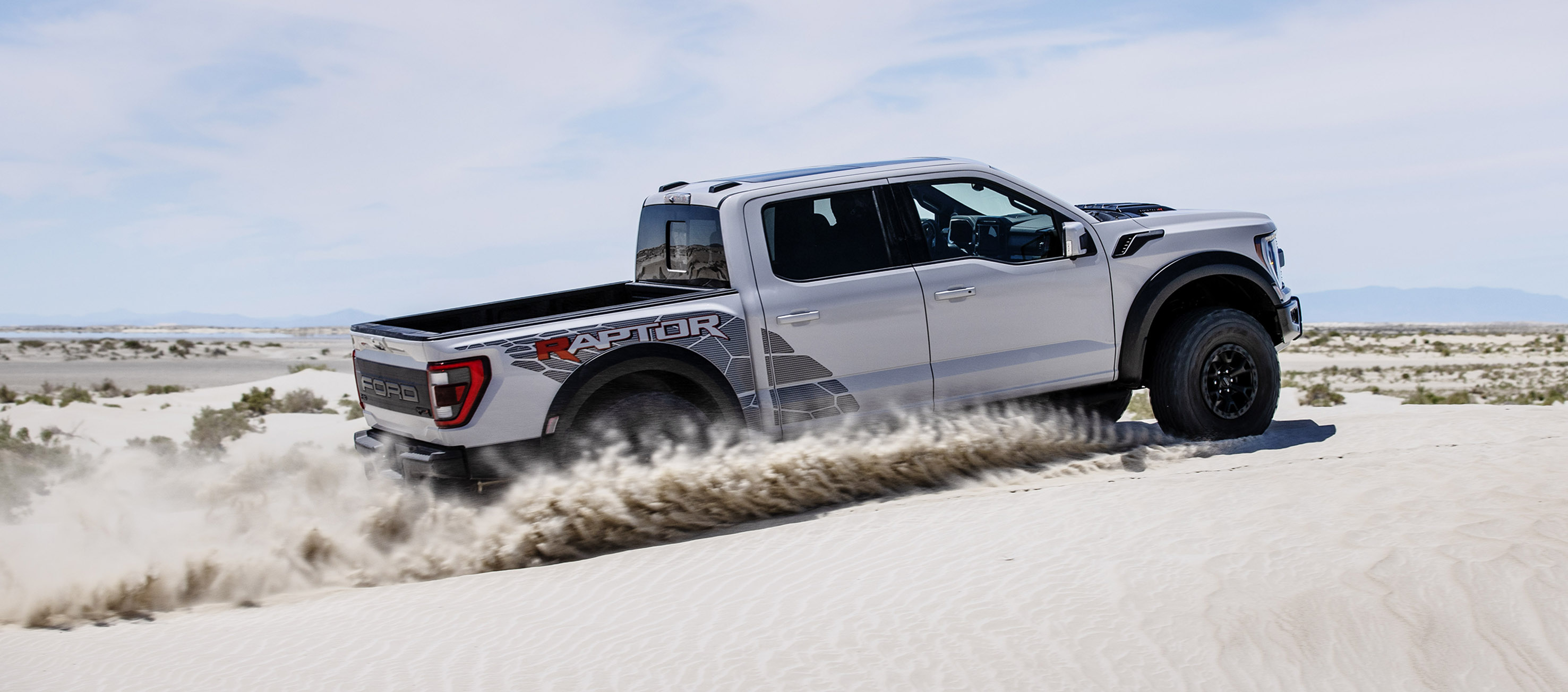 Preproduction model with optional equipment shown. Available late 2022.
Professional driver on a closed course. Always consult the Raptor supplement to the Owner’s Manual before off-road driving, know your terrain and trail difficulty, and use appropriate safety gear.
