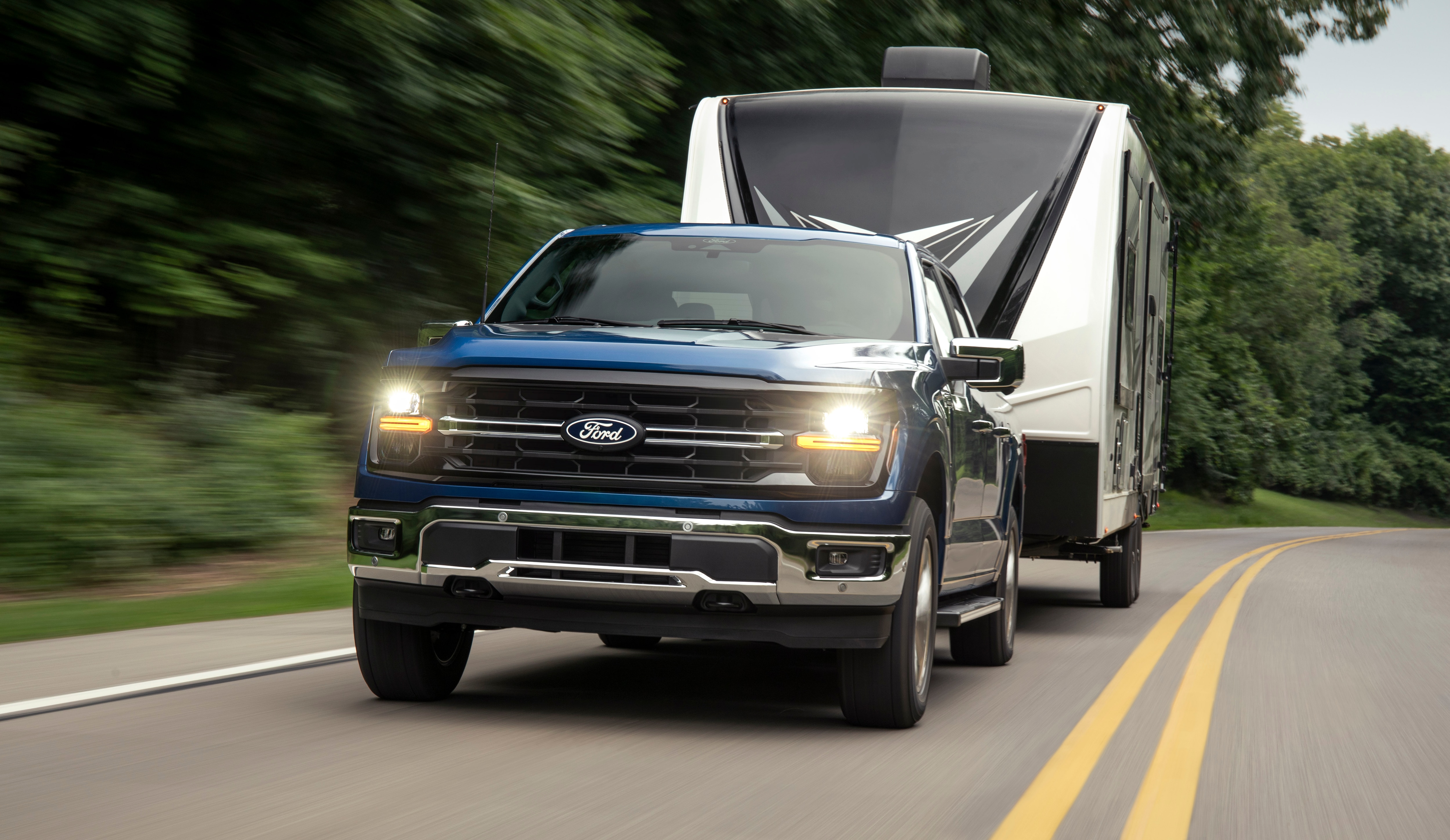 A 2024 Ford F-150 XLT tows a camper