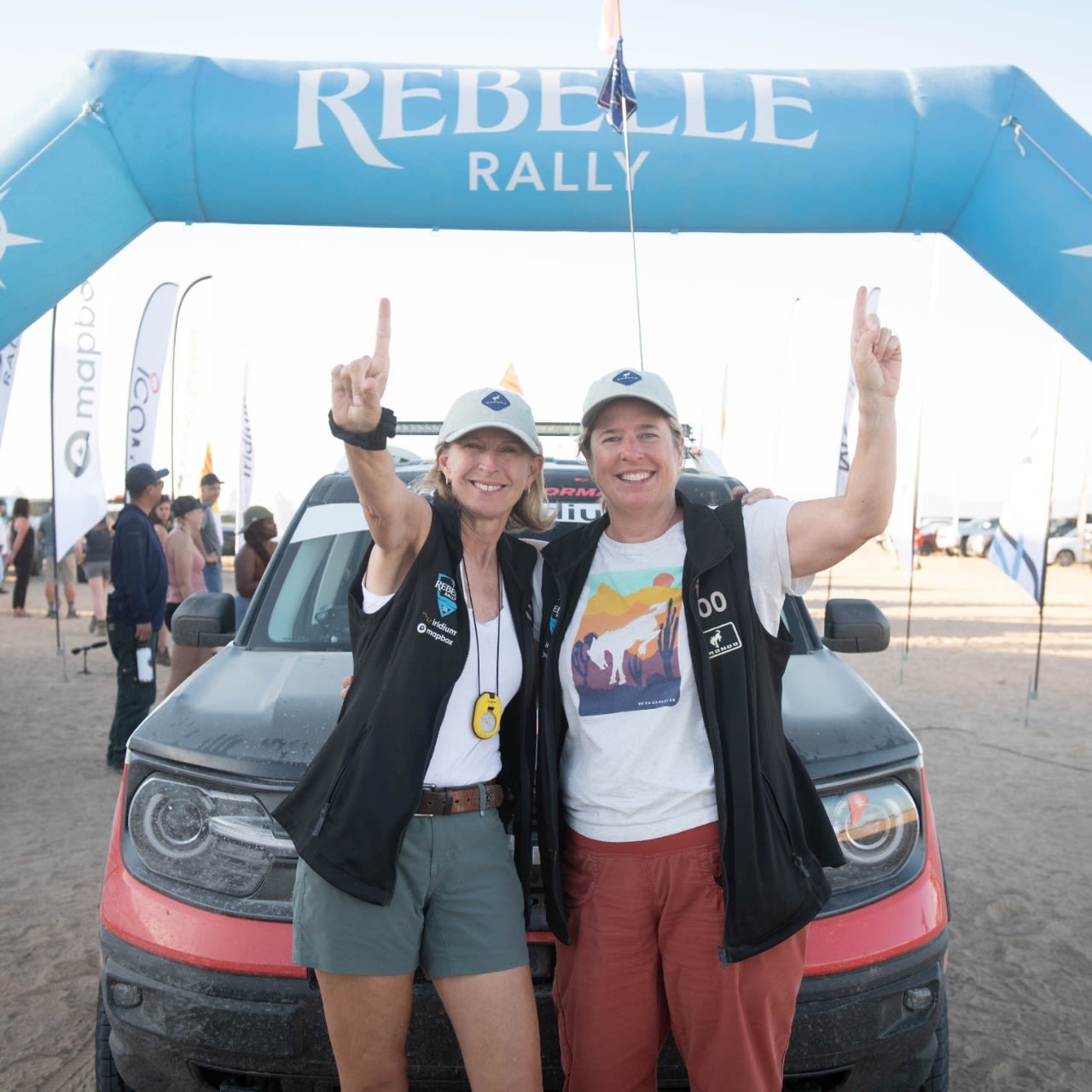 Two women pose with a Ford vehicle at the Rebelle Rally.