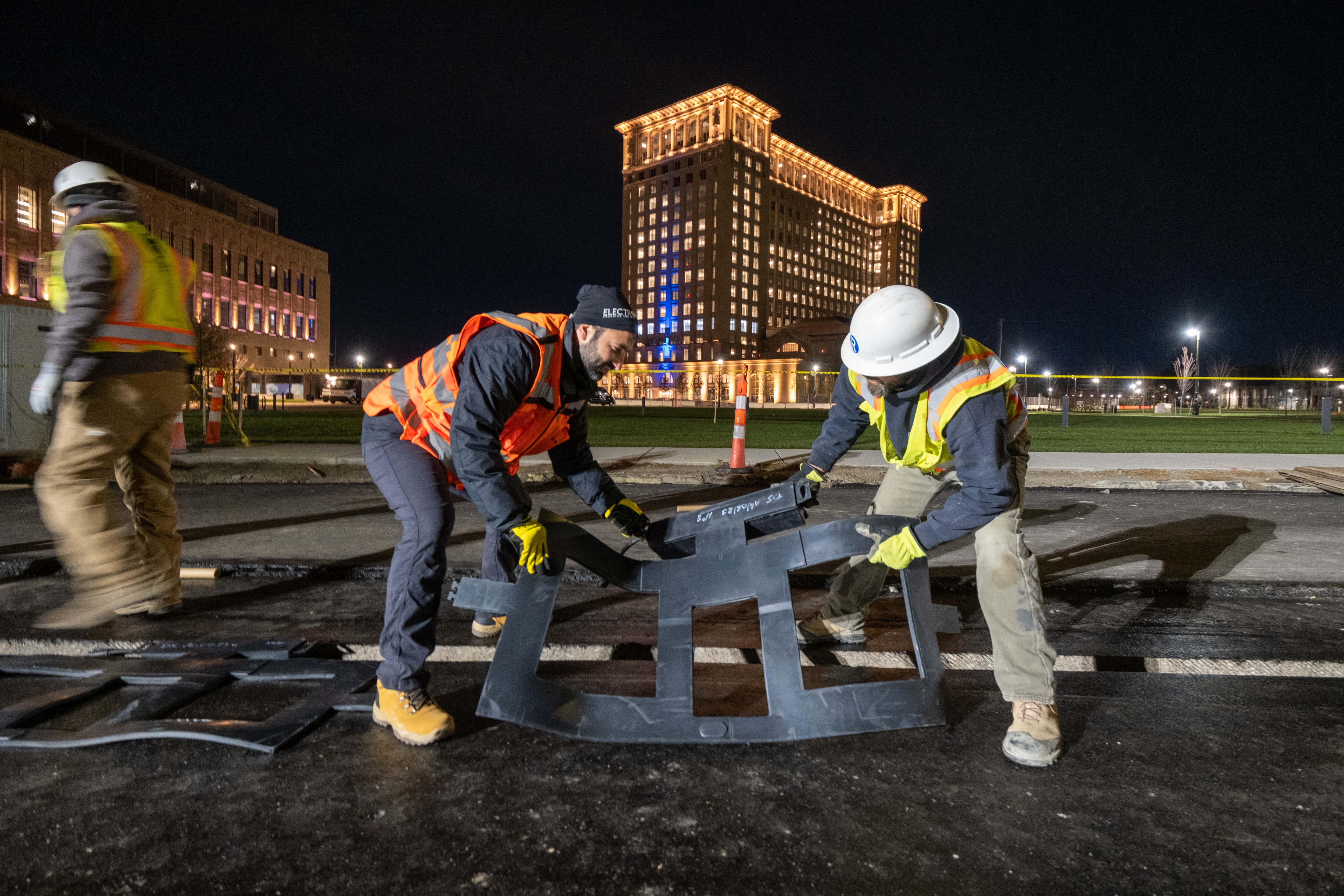 Two men wearing construction gear lift material