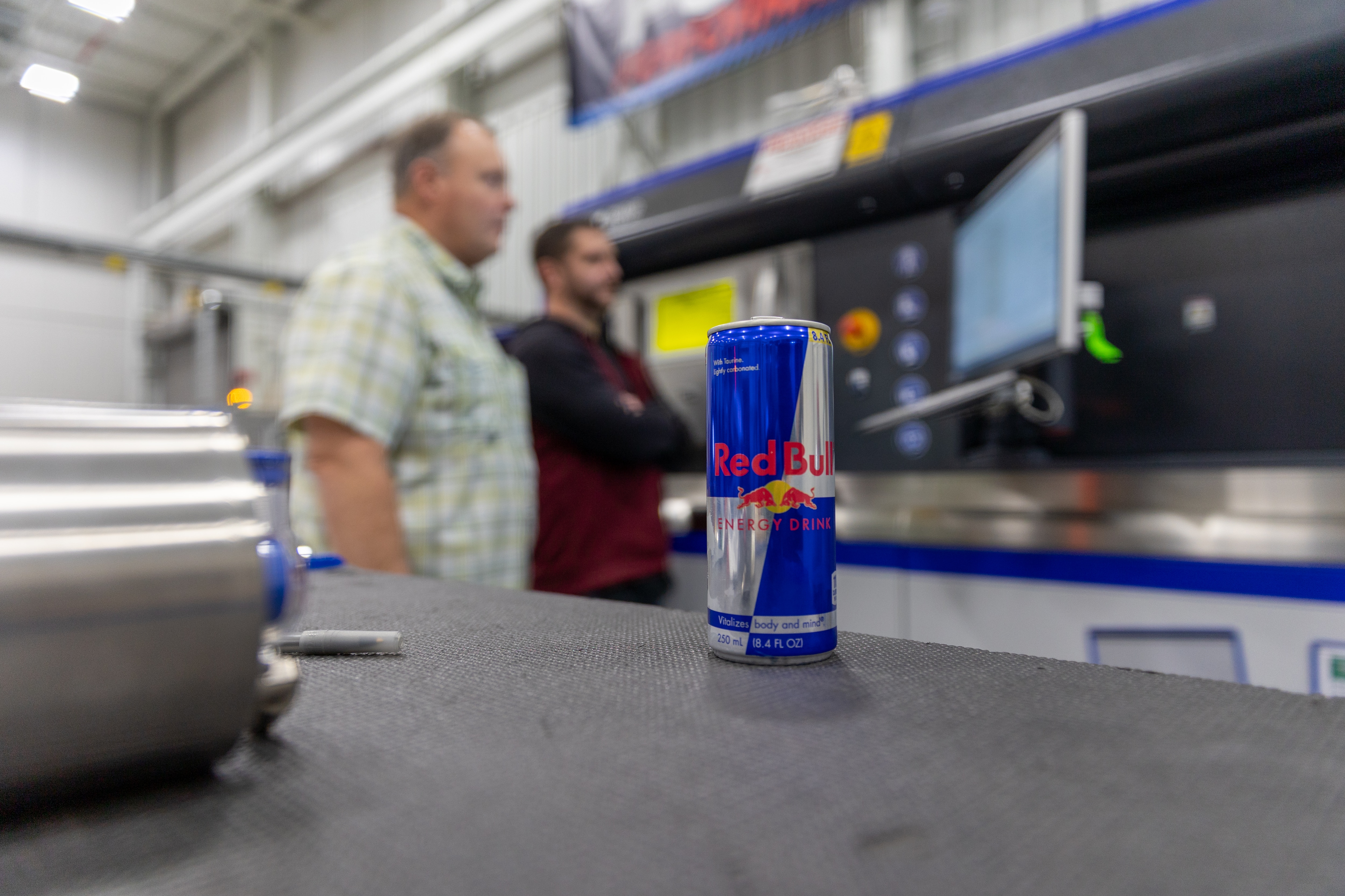 A redbull can in the foreground of Ford’s additive manufacturing team