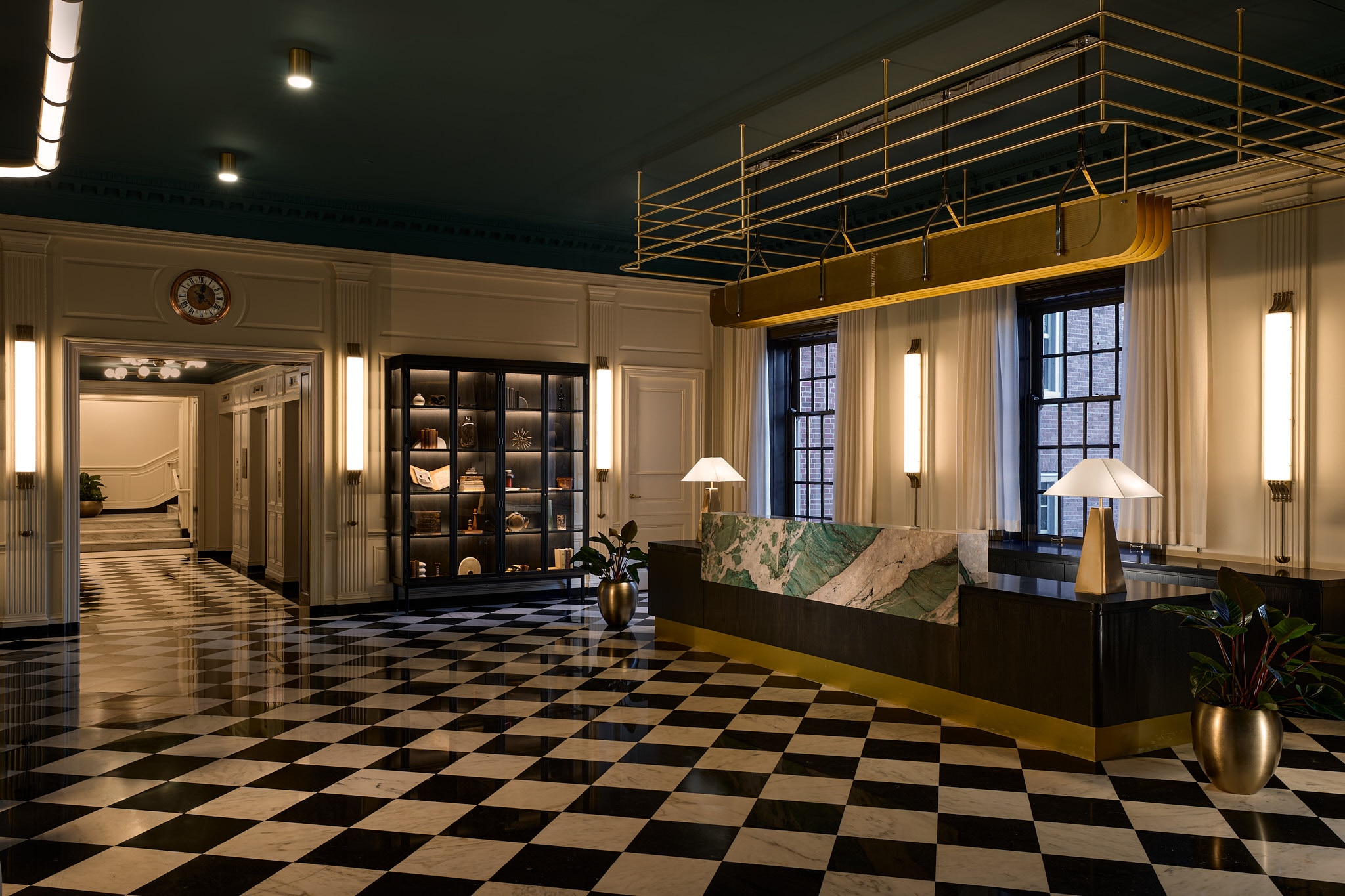The front desk of the newly renovated Dearborn Inn is shown upon black-and-white checkered marble floors in the lobby