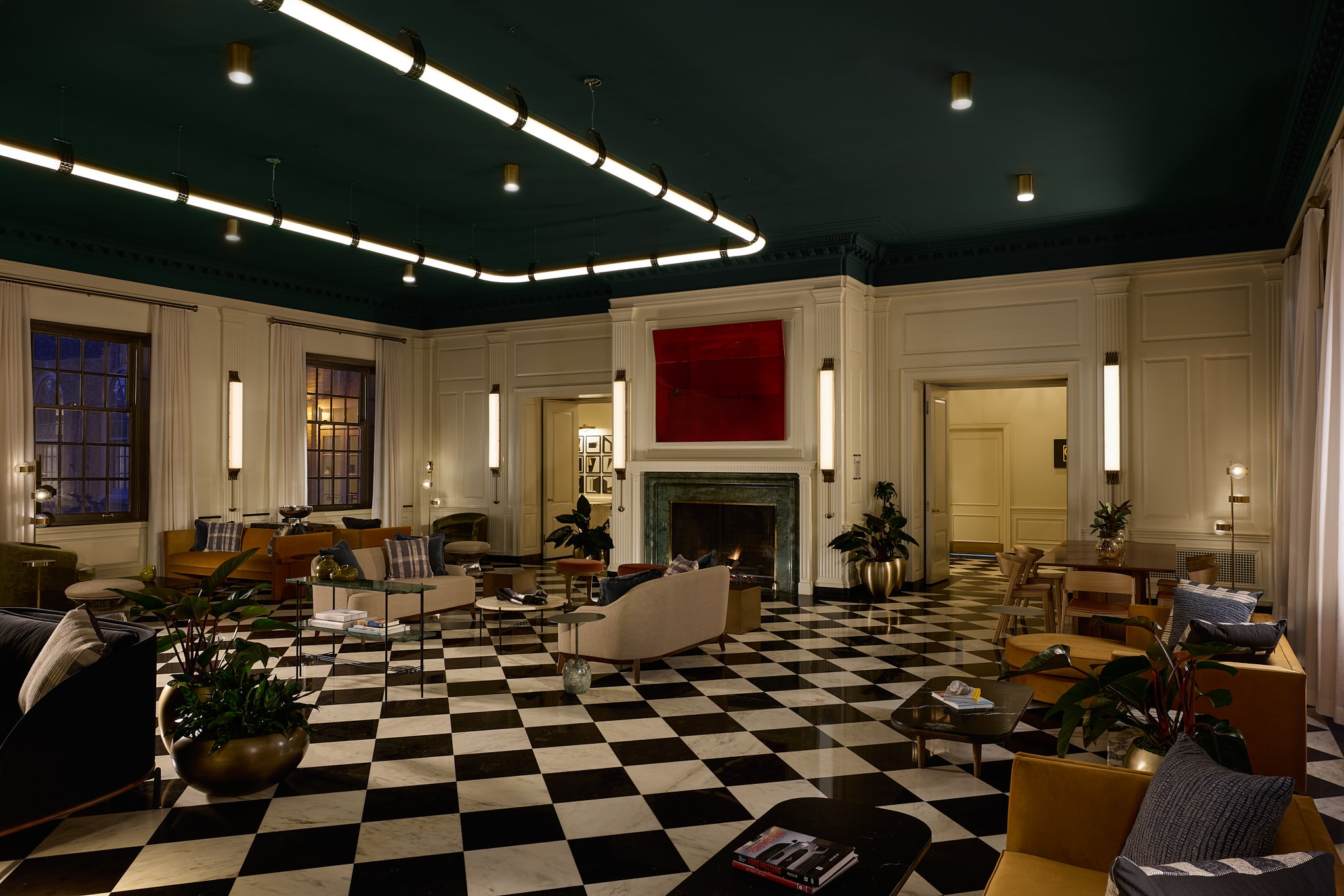 The newly renovated Dearborn Inn lobby is pictured with black-and-white checkered floors, low lighting and a luxurious ambiance 