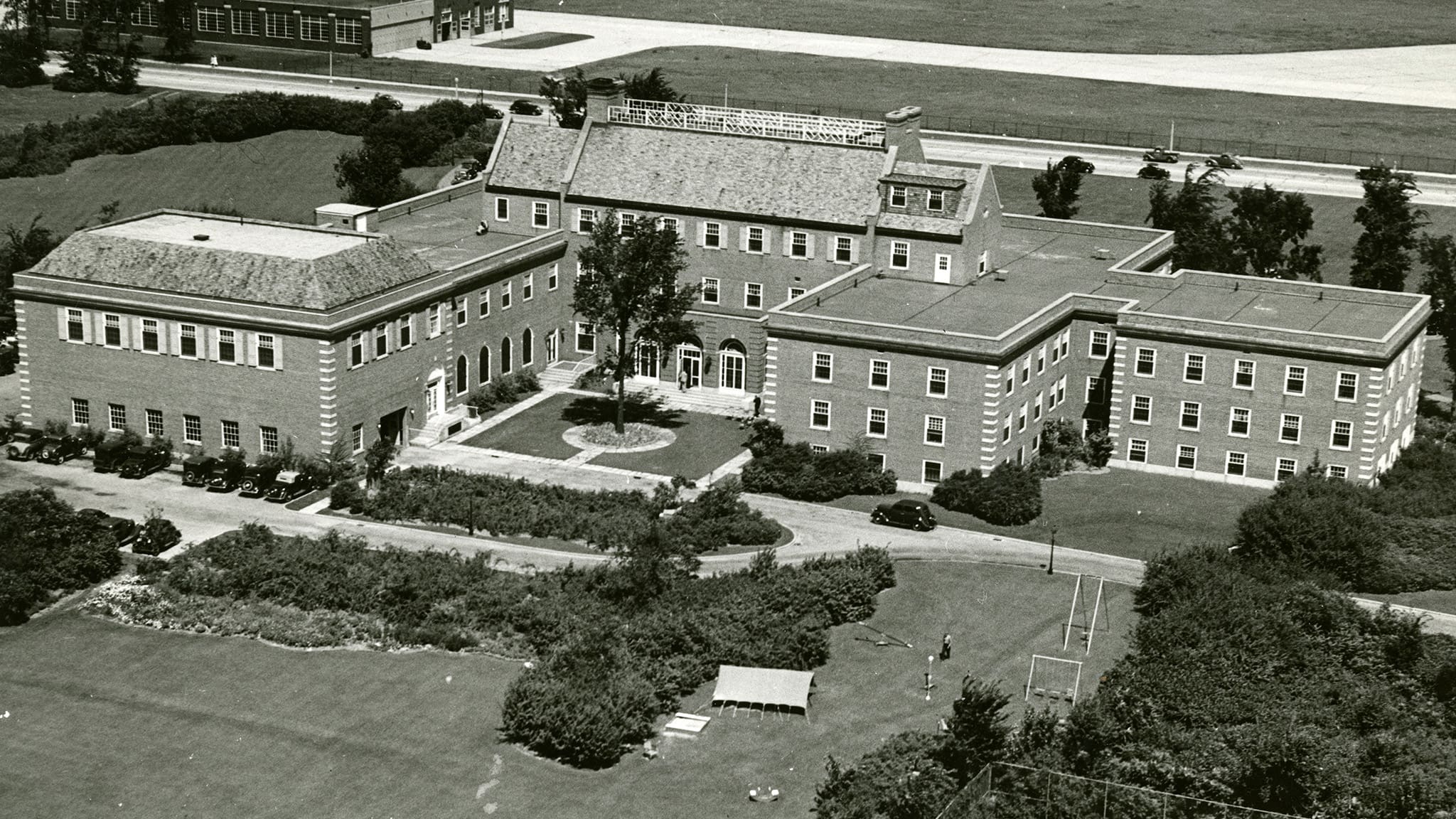 A historic black-and-white image of the Dearborn Inn, opened in 1931