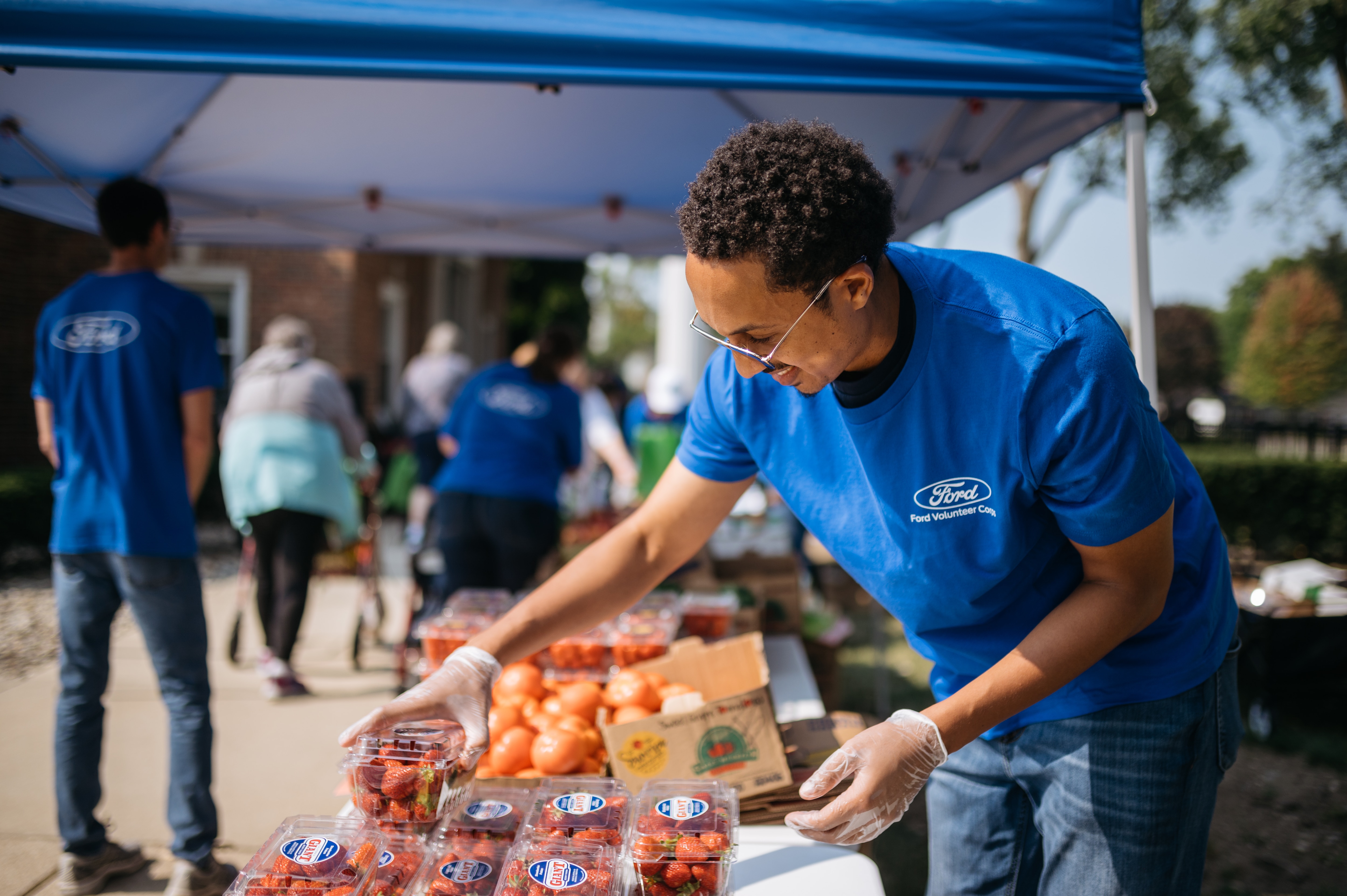 A Ford volunteer works at a food pantry