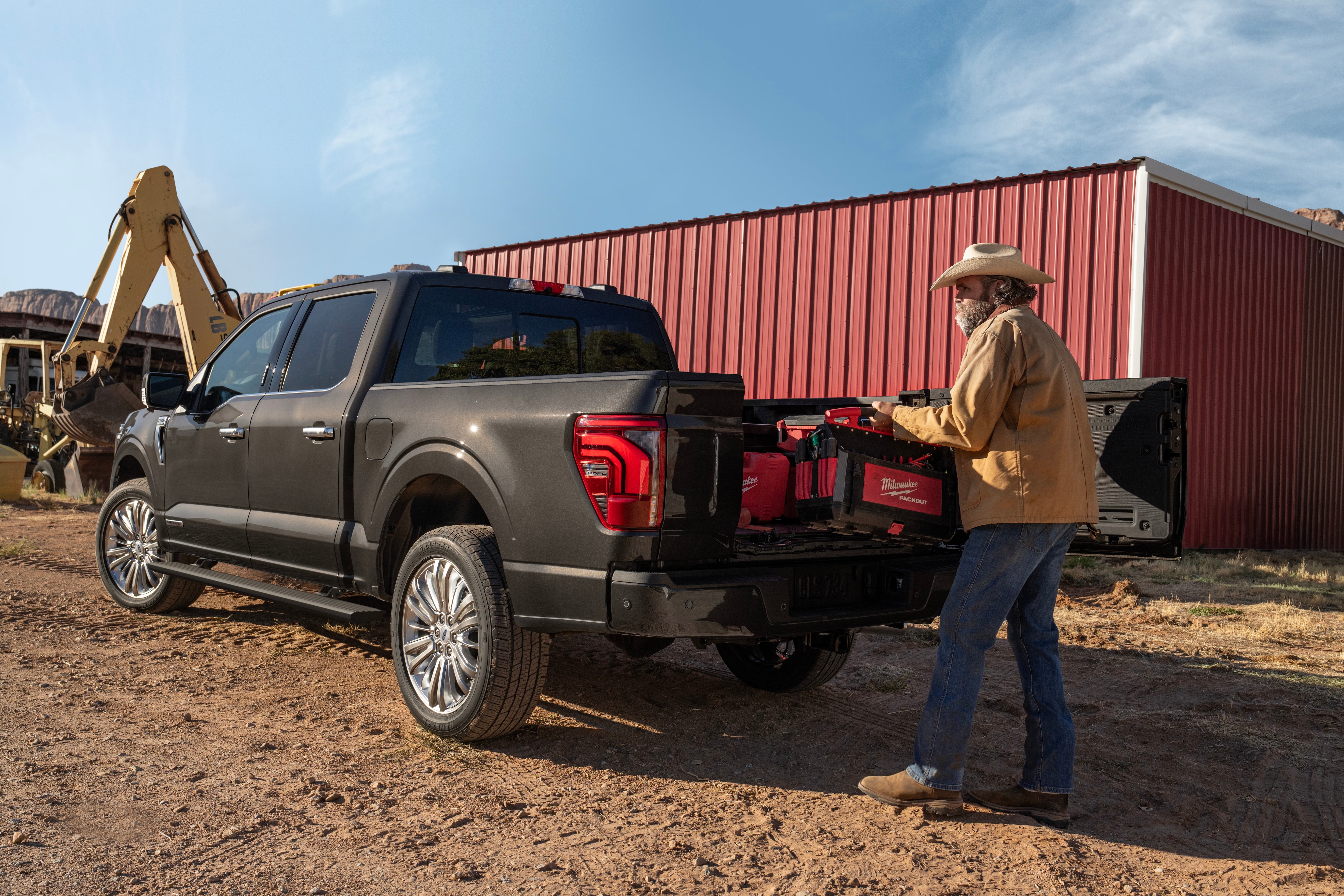 A man loads tools into a truck