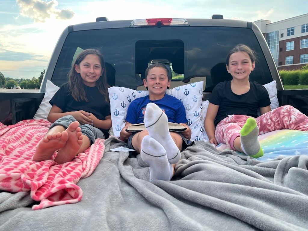 Vince Mahe, chief engineer for the F-150 Lightning, uses Pro Power Onboard in the Mega Power Frunk to inflate a mattress for drive-in movie nights.