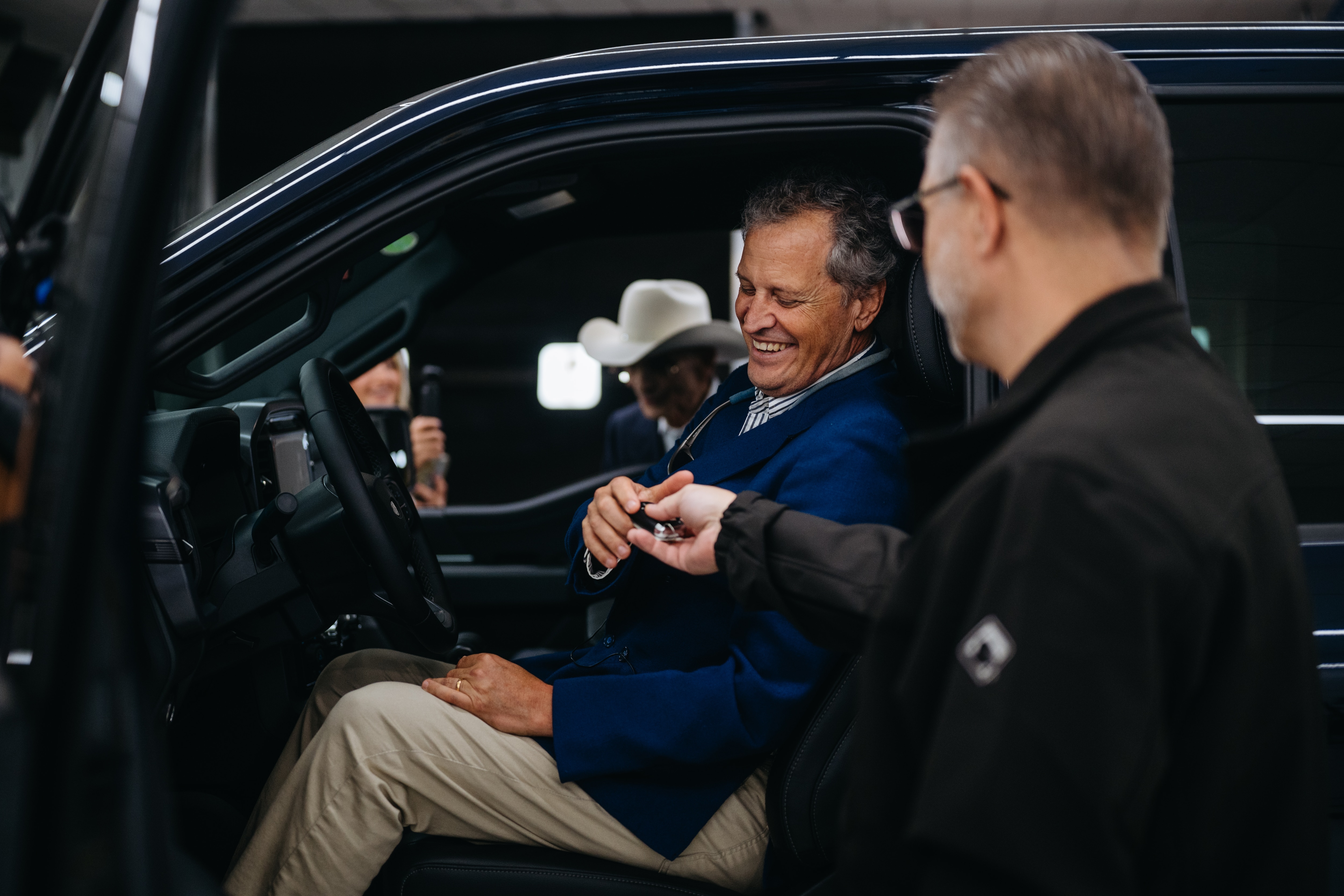 F-150 Chief Engineer John Lo Porto hands Marc Fogel the keys to his new Ford F-150 truck.
