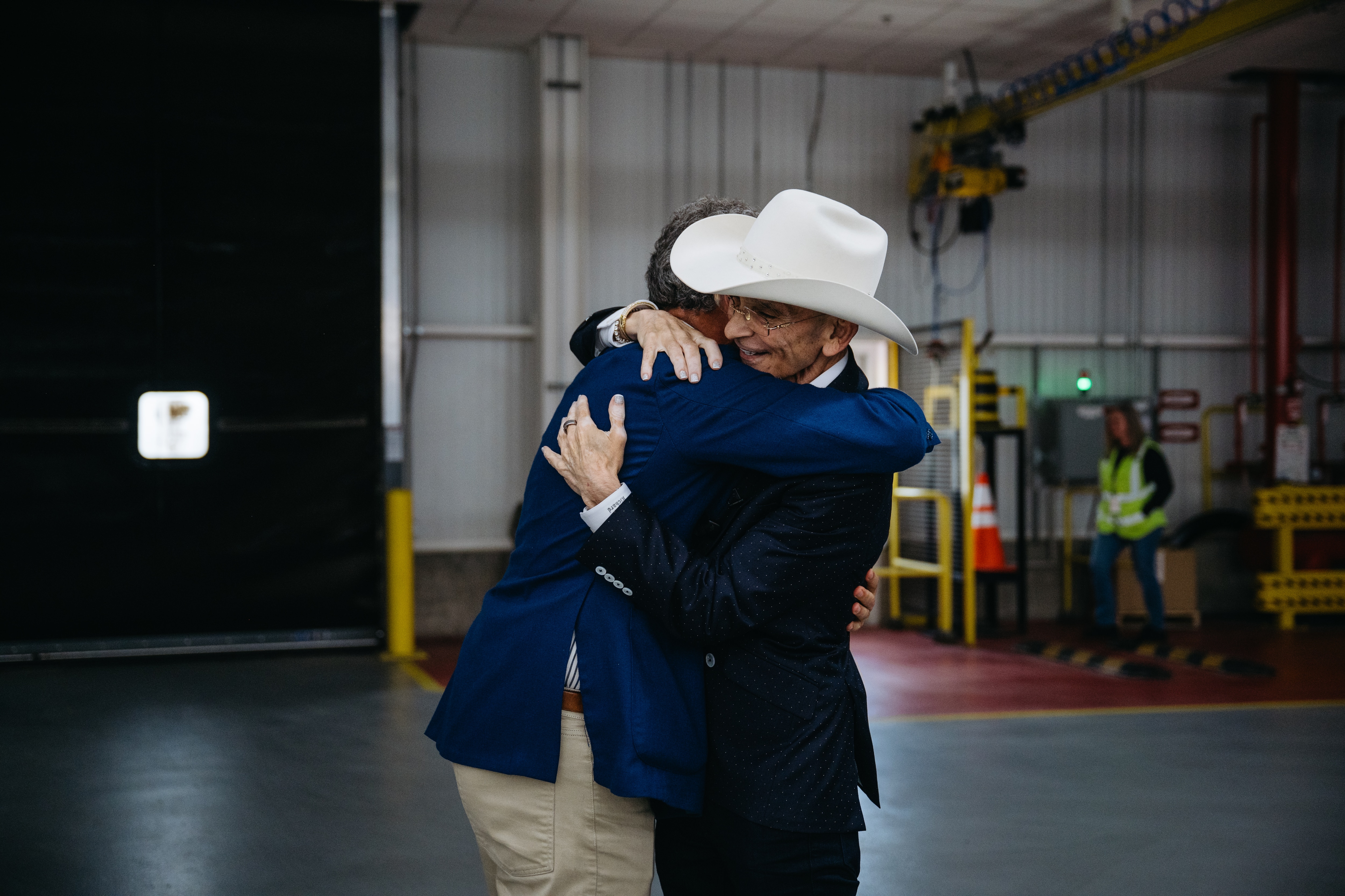 Marc Fogel embraces Richard Bazzy upon being surpised with a new Ford F-150 truck at Dearborn Truck Plant on Monday, May 5, 2025.