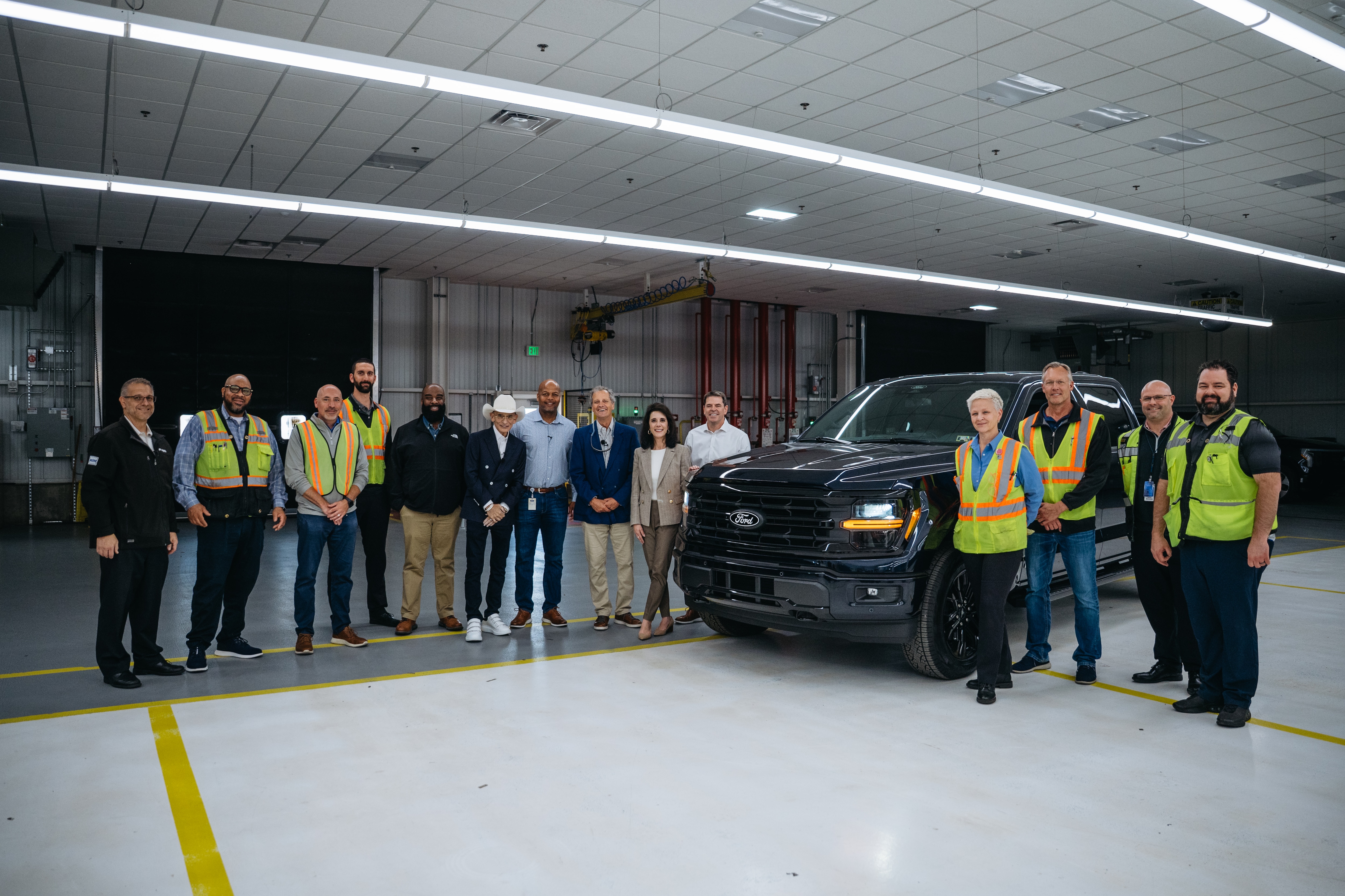 The Dearborn Truck Plant leadership team flanks F-150 Chief Engineer John Lo Porto, Richard Bazzy, owner of Shults Ford and Shults Lincoln in Pennsylvania, Dearborn Truck Plant Manager Corey Williams, Marc Fogel, an American history teacher who recently returned home after being wrongfully detained in Russia, Lisa Materazzo, Ford Global Chief Marketing Officer, Michael O’Brein, Ford Director of Global Dealer Engagement at Dearborn Truck Plant on Monday, May 5, 2025. It was during the visit Fogel was surprised by Shults Ford with a new F-150 truck as a welcome home gesture. (Optional equipment shown.)