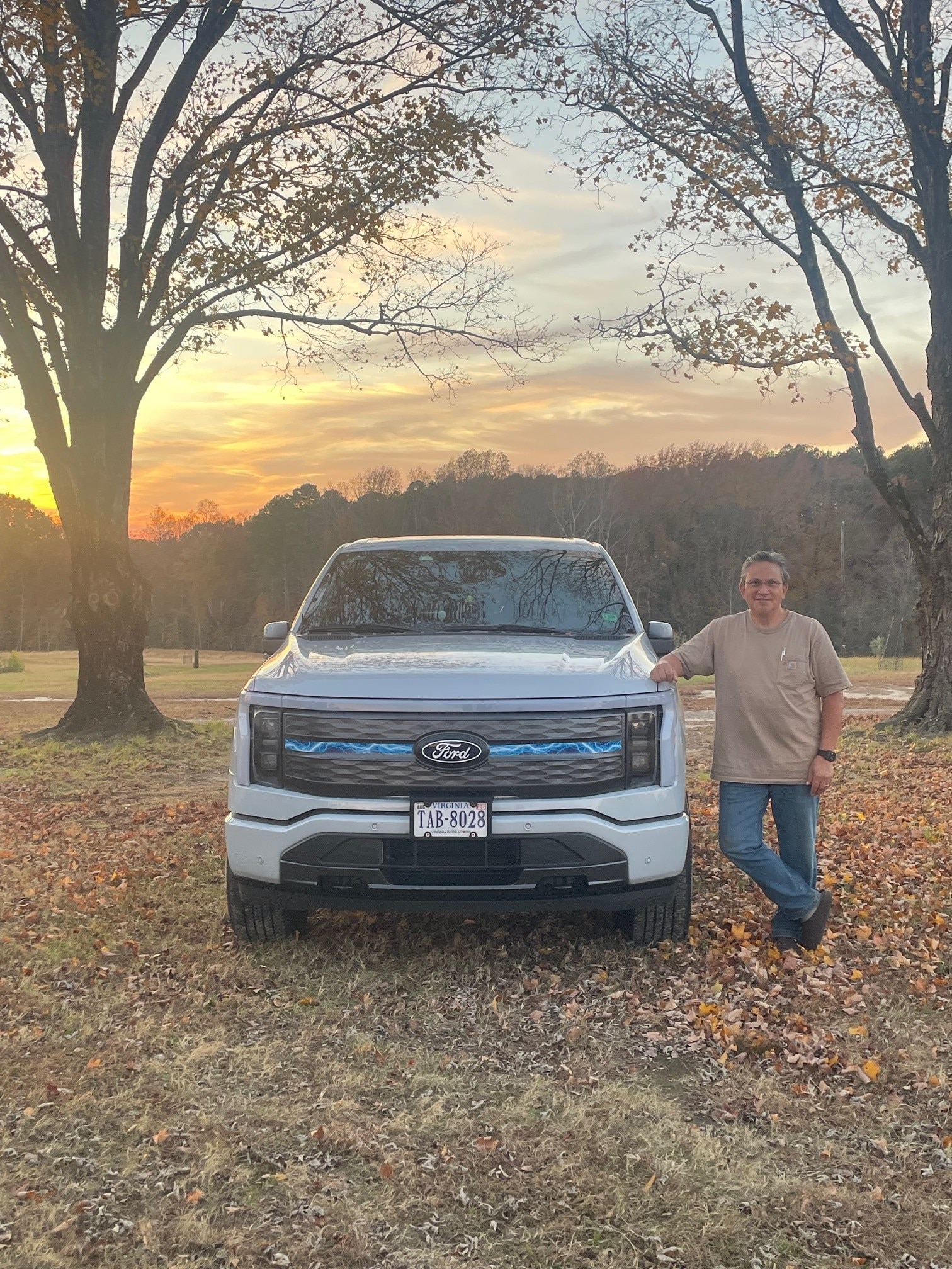 A man poses with his Ford truck.