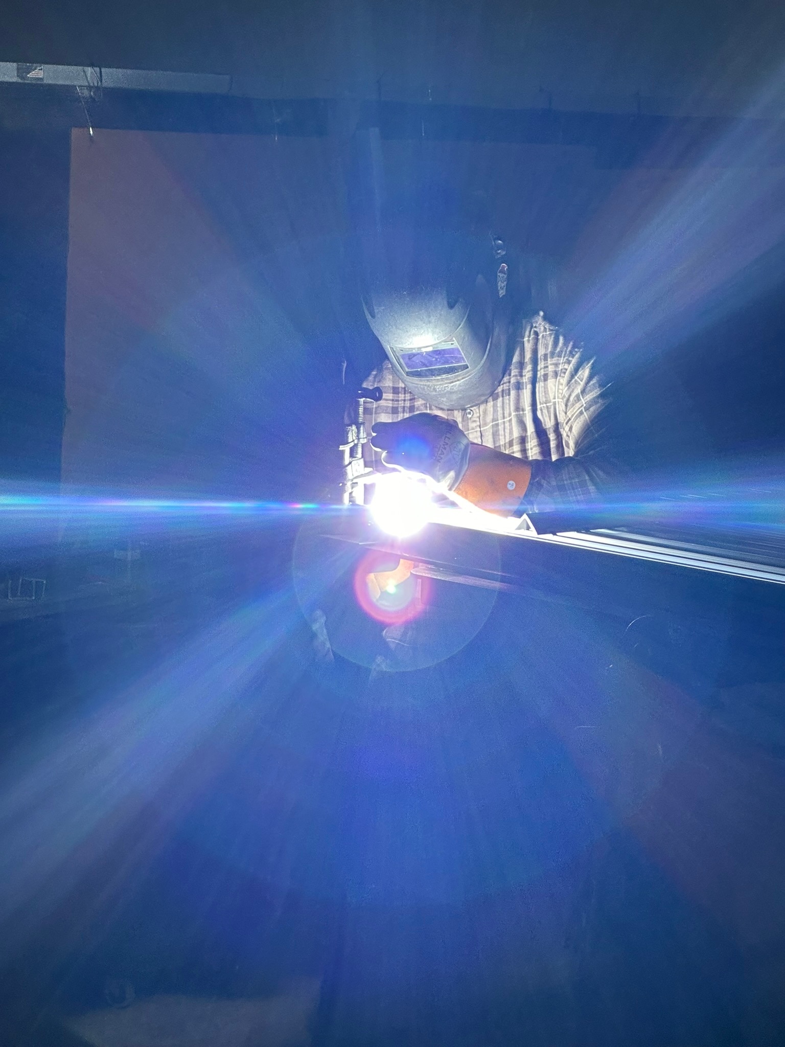 A person in welding mask works 