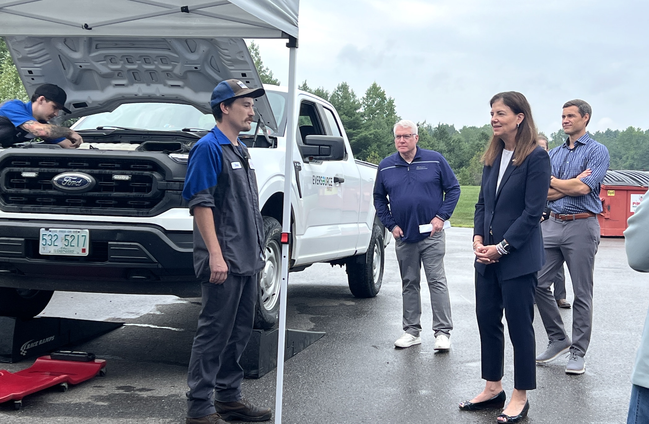 Ford Mobile Service technician Dave Bosquet talks with Governor Ayotte during a food drive on July 31 where Grappone Ford offered complimentary oil changes in exchange for donated goods. Bosquet attended the Boys and Girls Club when he was younger.