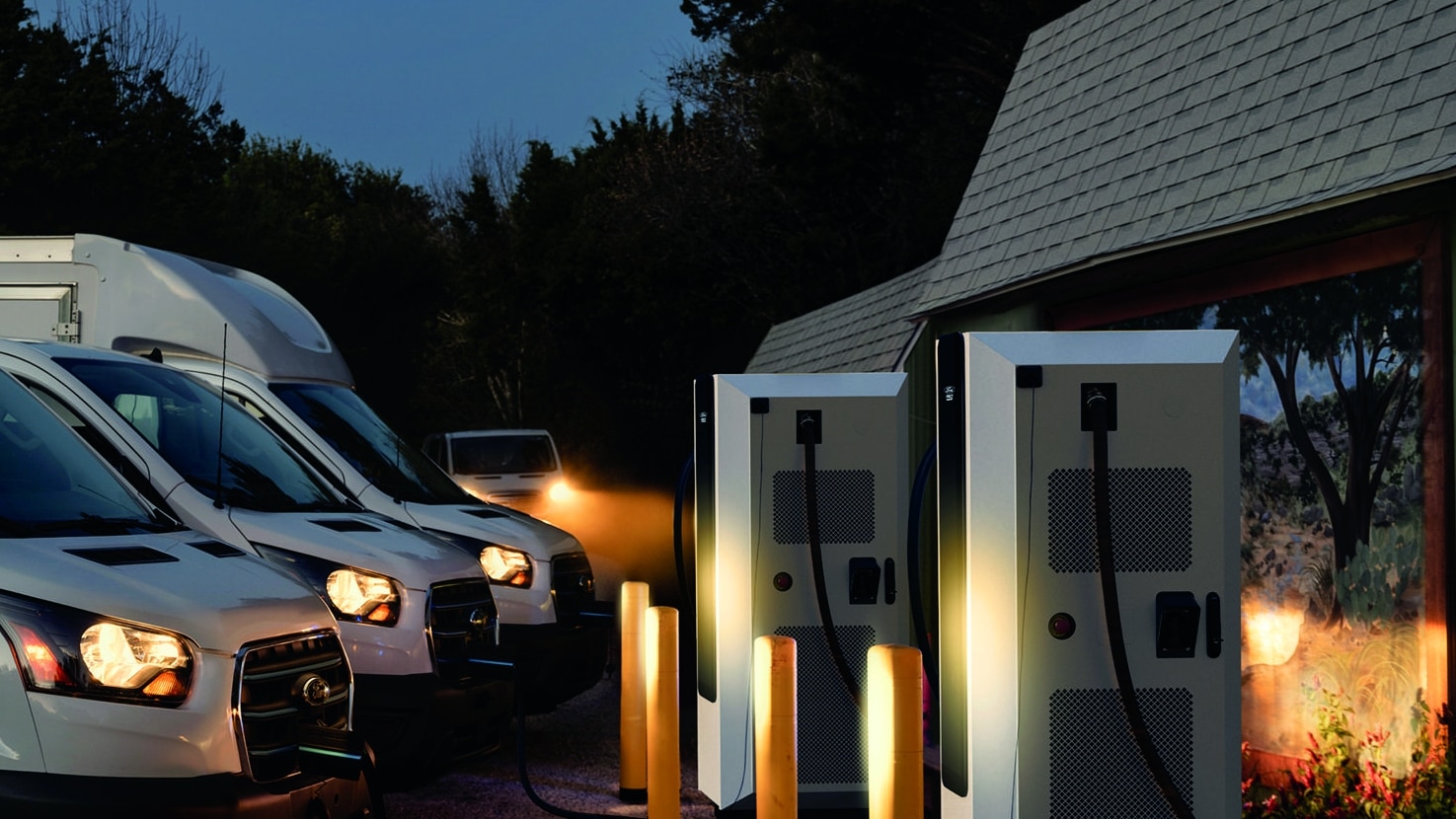 Electric vehicles are plugged into chargers at a business.