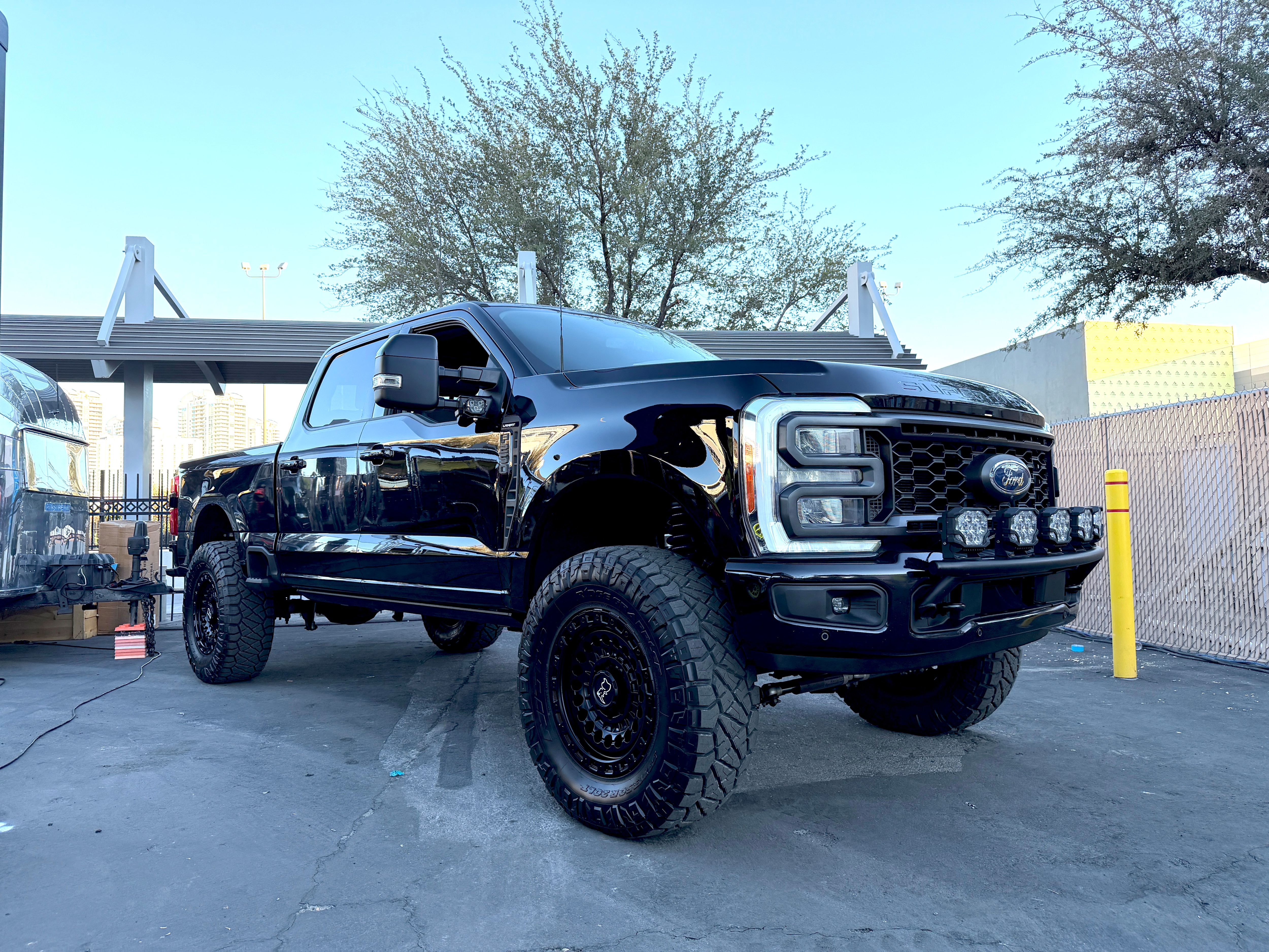 A large black truck displayed at a car show