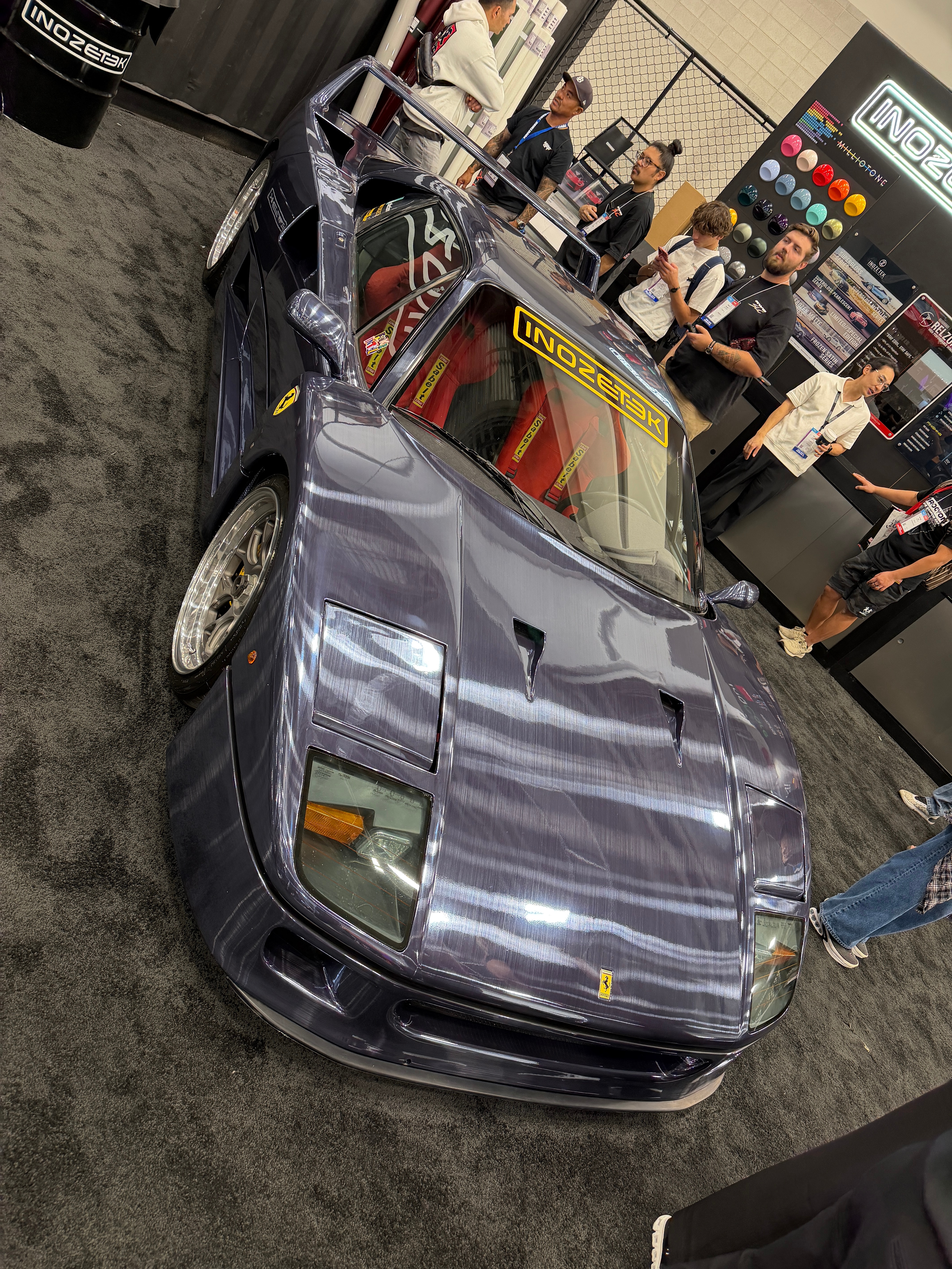 A purple sports car displayed at a car show
