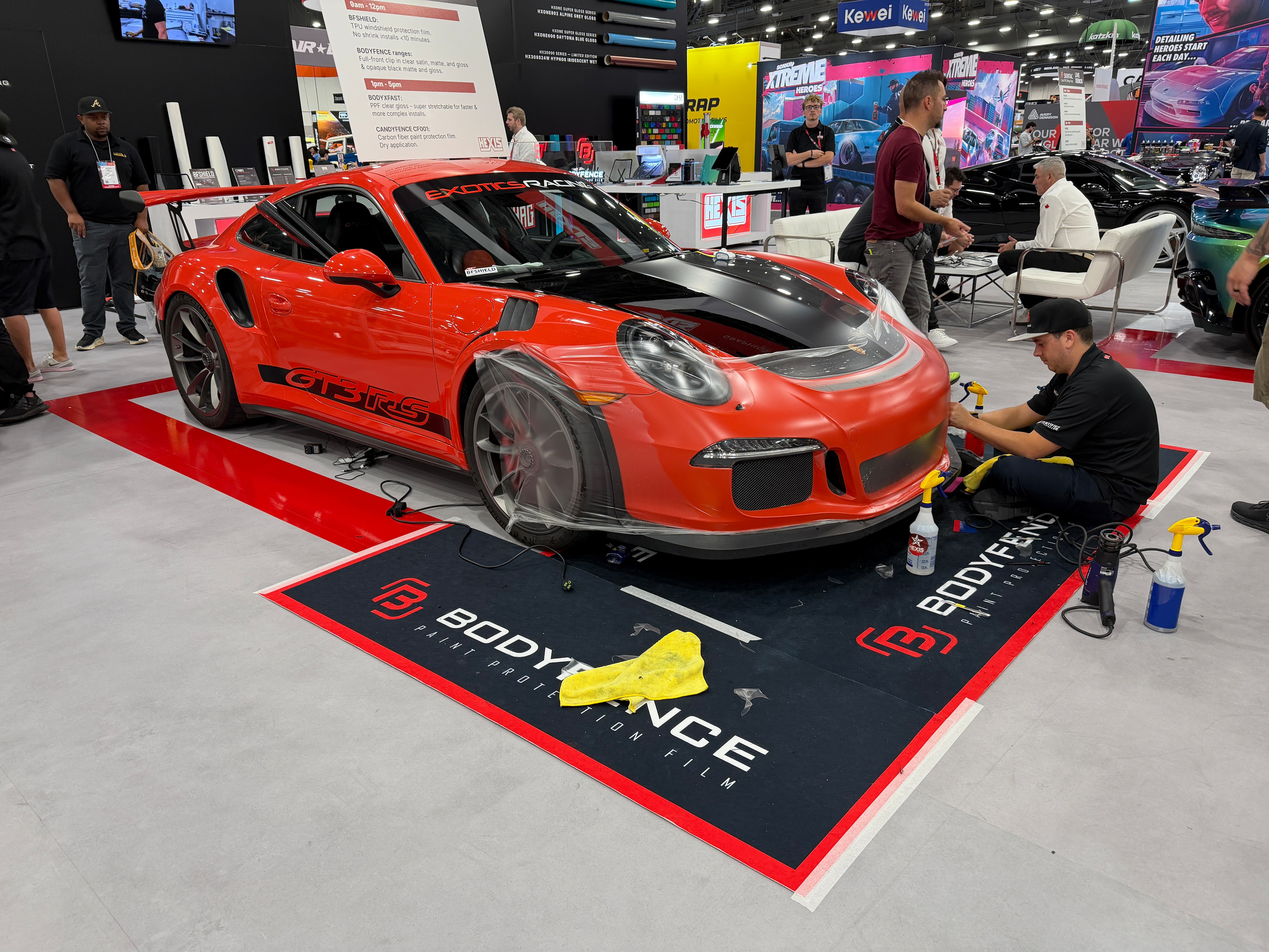 A red sports car displayed at a car show