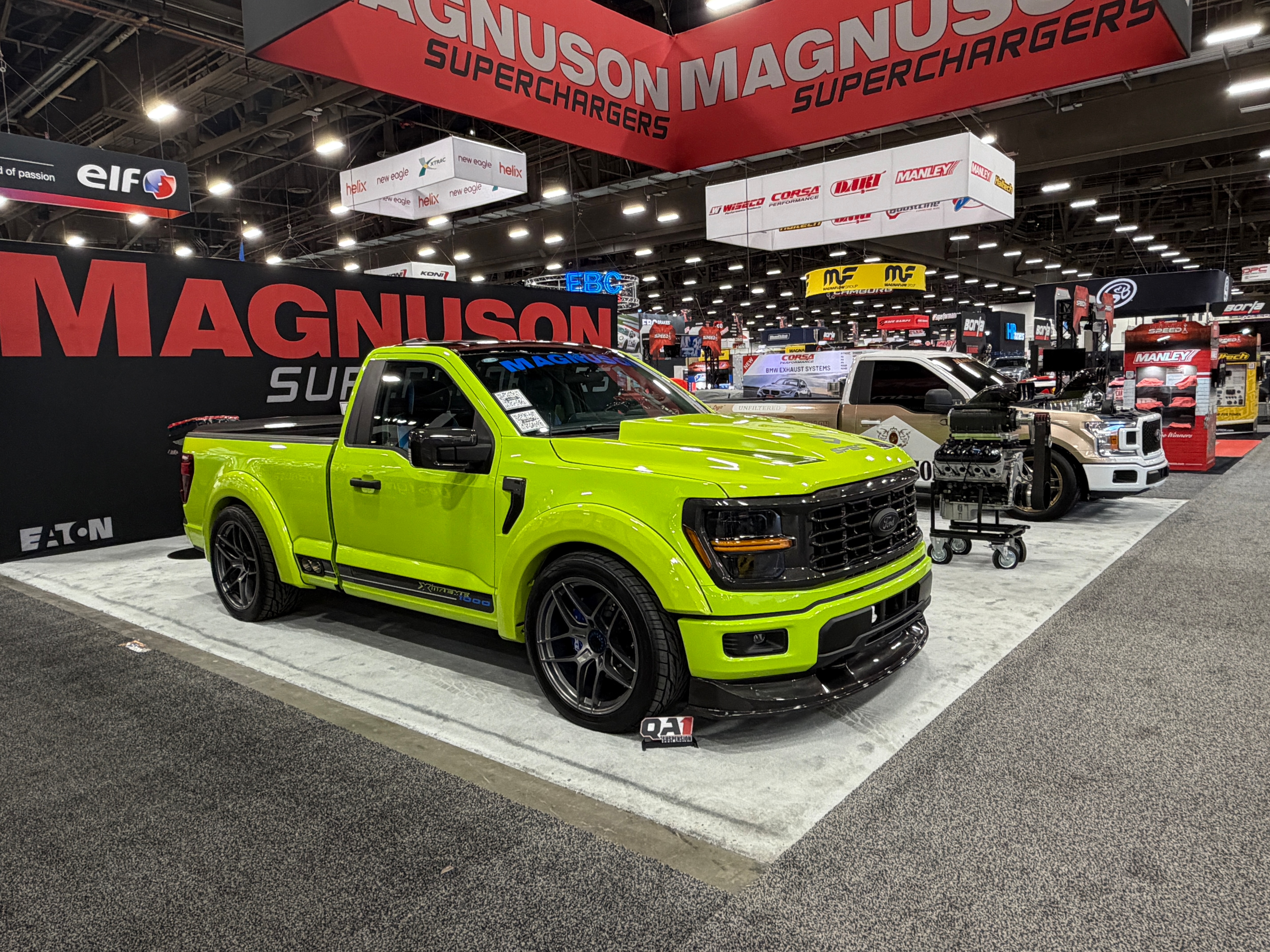 A bright green truck displayed at a car show