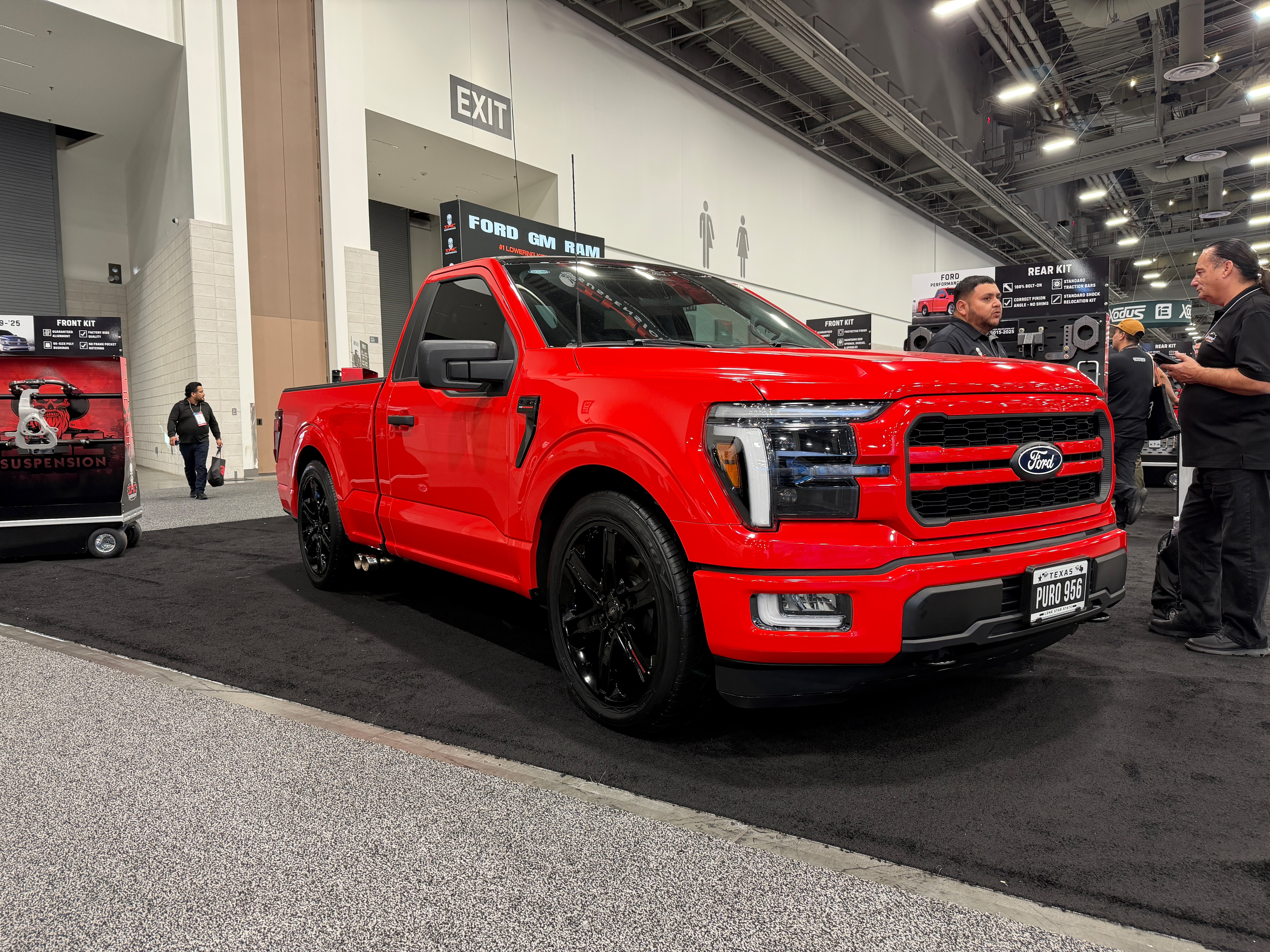 A bold red truck displayed at a car show