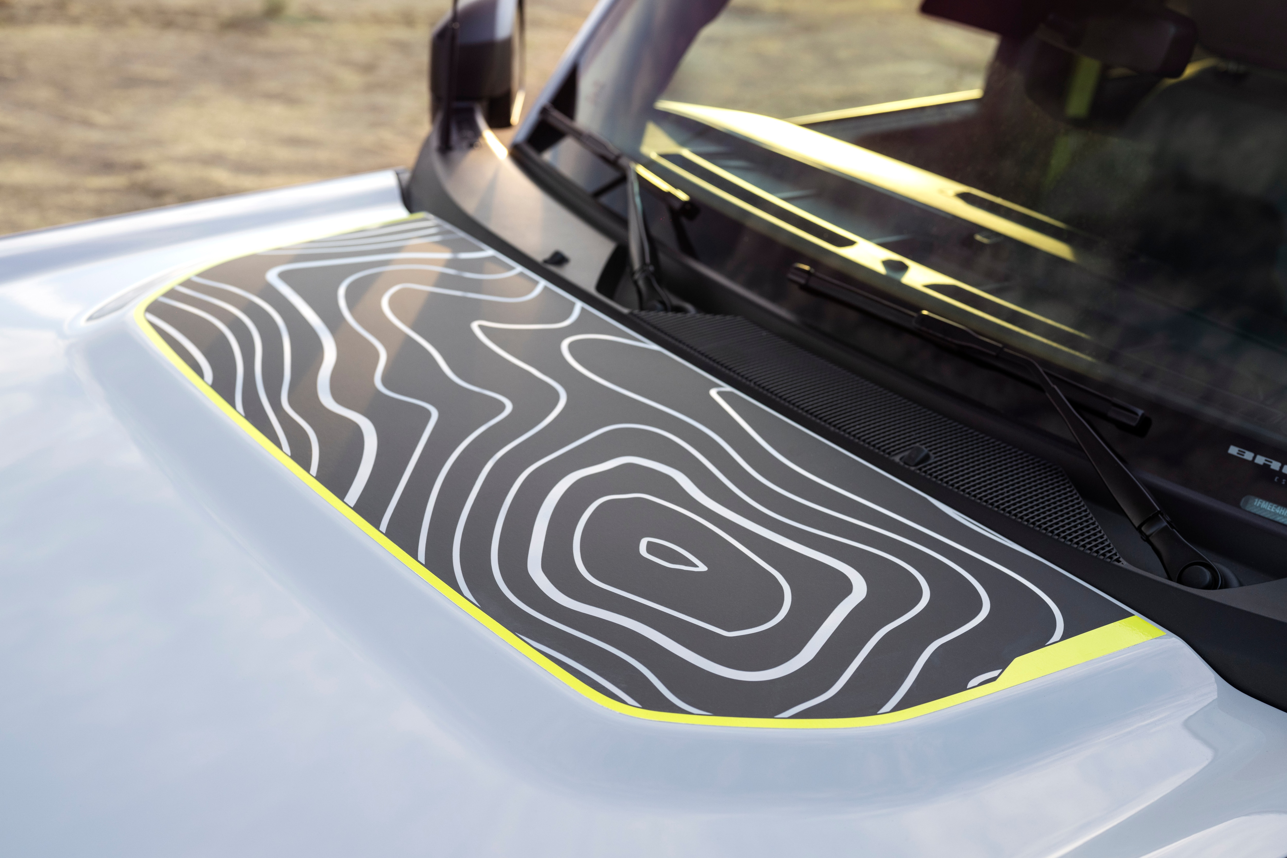 Lime green highlights and topographical map-like design shown on the hood of the Bronco RTR.