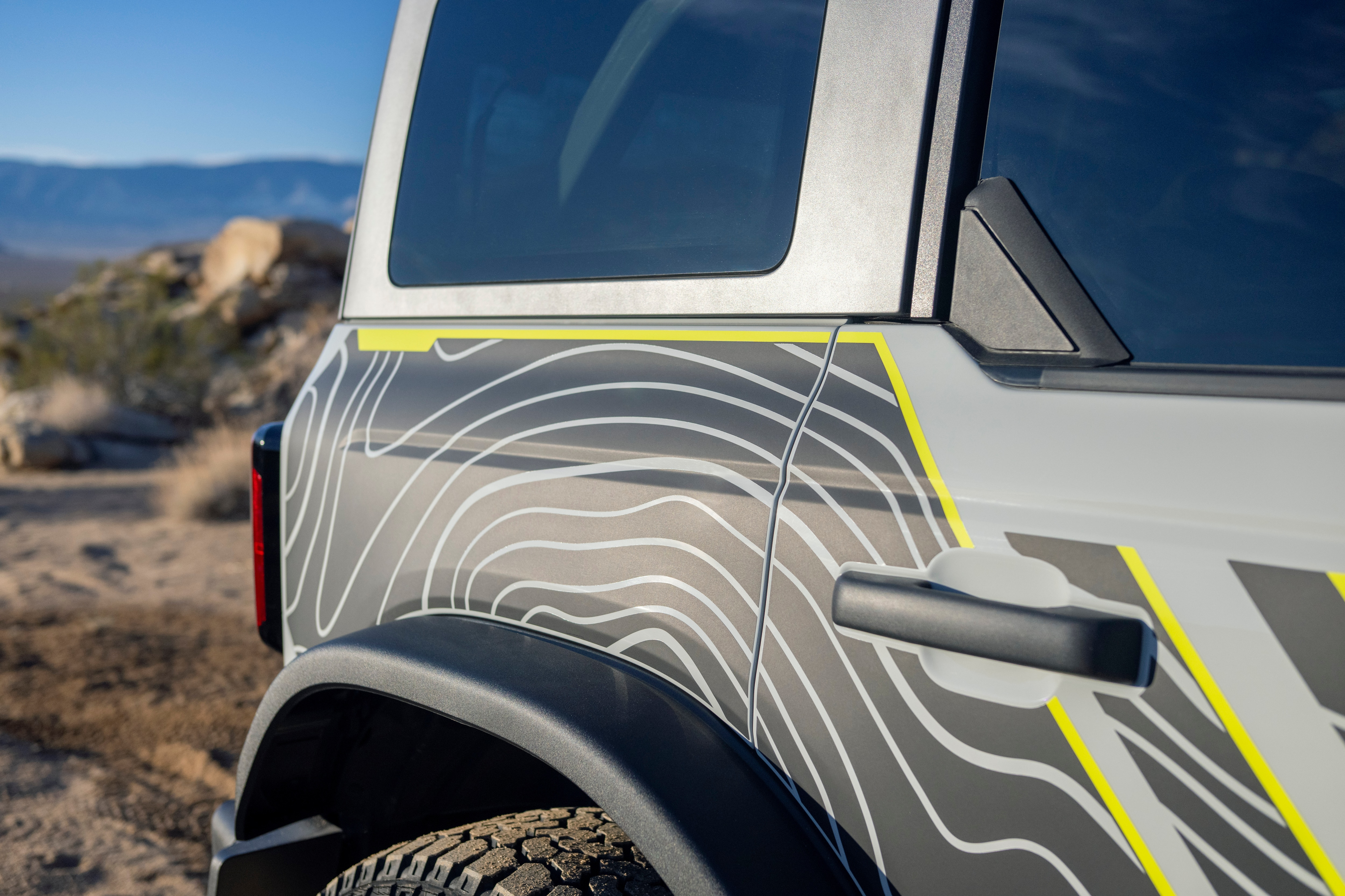 Lime green highlights and topographical map-like design shown on the side of the Bronco RTR.