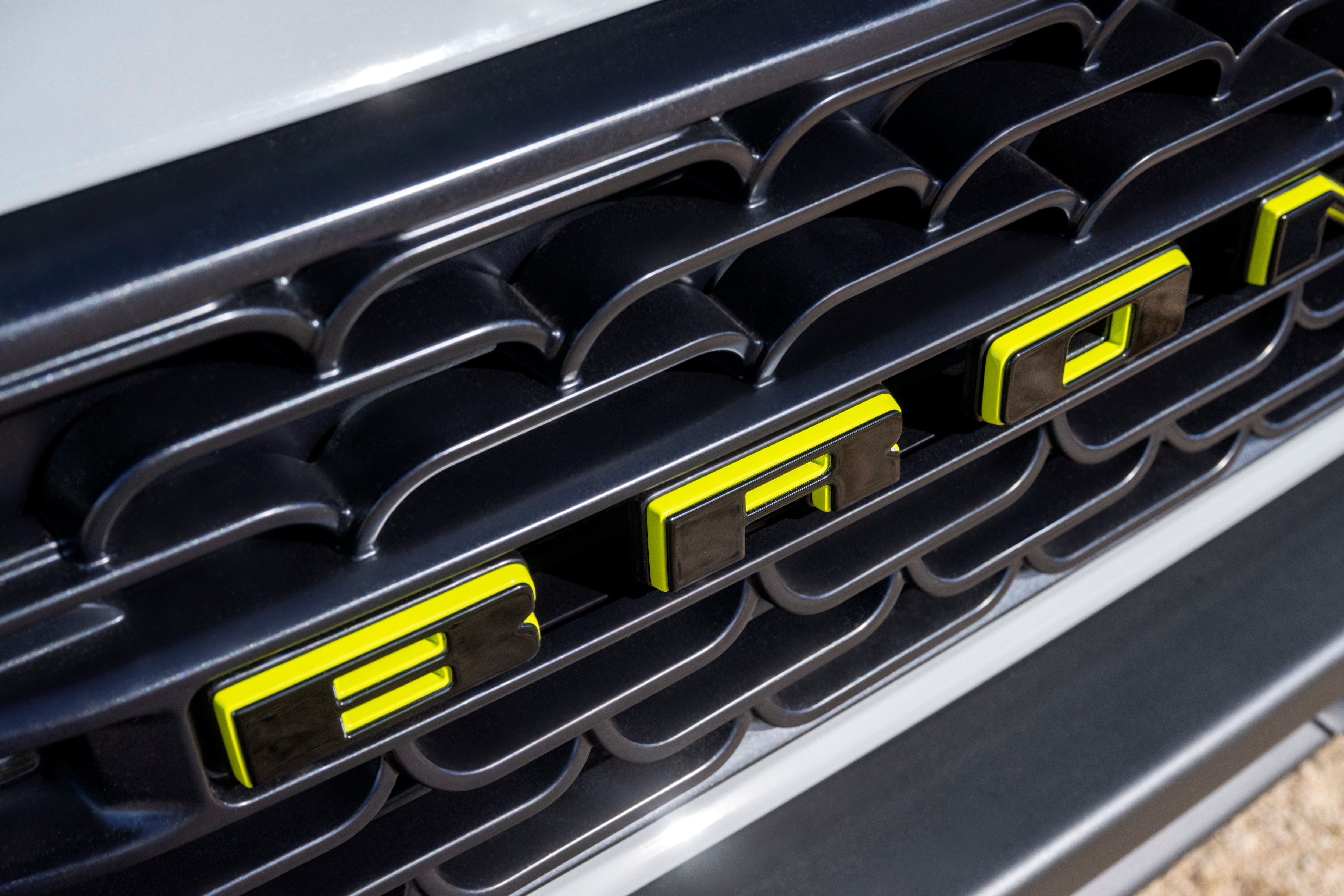 The front grille of the Bronco RTR shows "BRONCO" with lime green on the letters.