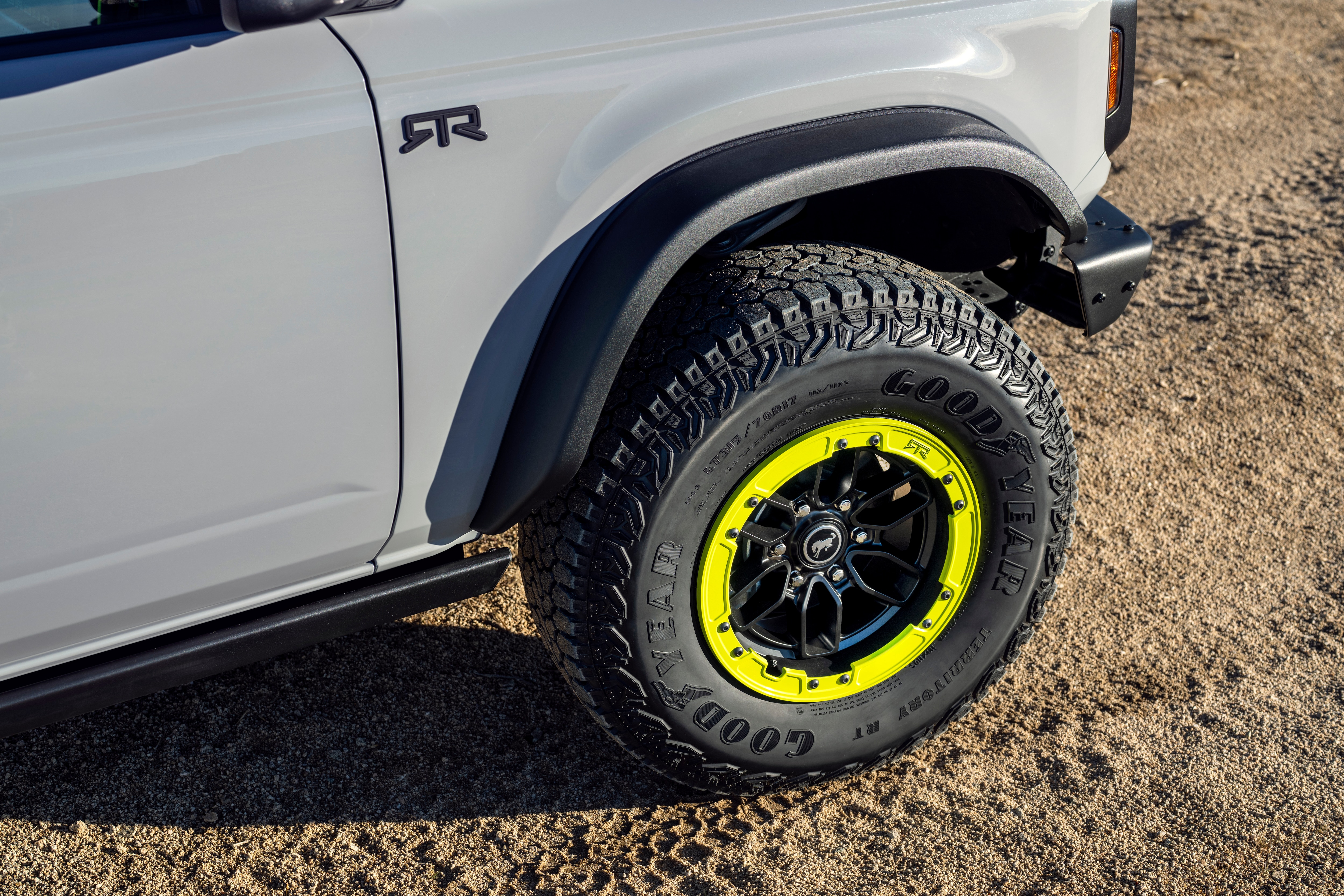 The front end of the Bronco RTR shows the RTR logo on the side of the vehicle and lime green accents in the wheel.