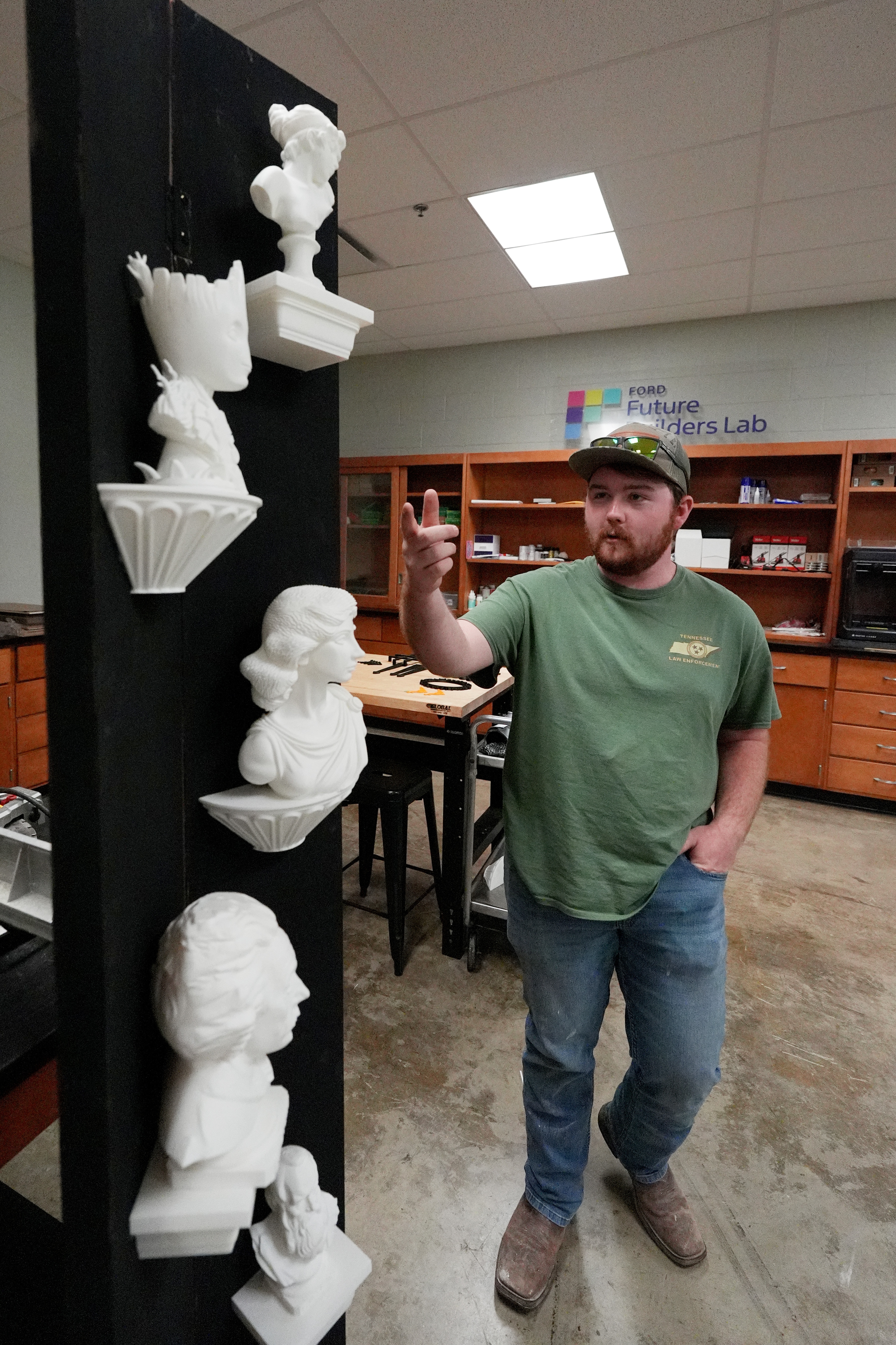 Wyatt Poole, 18, a senior at Haywood High School in Brownsville, Tenn., explains how he and other students used 3D printers to make the prop figurines of an upcoming student play based on the Disney movie “Frozen,” in the school’s Ford Future Builders Lab April 14, 2026. The lab is one of several that opened this academic year in West Tennessee to assist K-12 students and their teachers to learn about tools of skilled trades, including laser cutting, 3D printing and coding. (Rogelio V. Solis for Ford Communications)