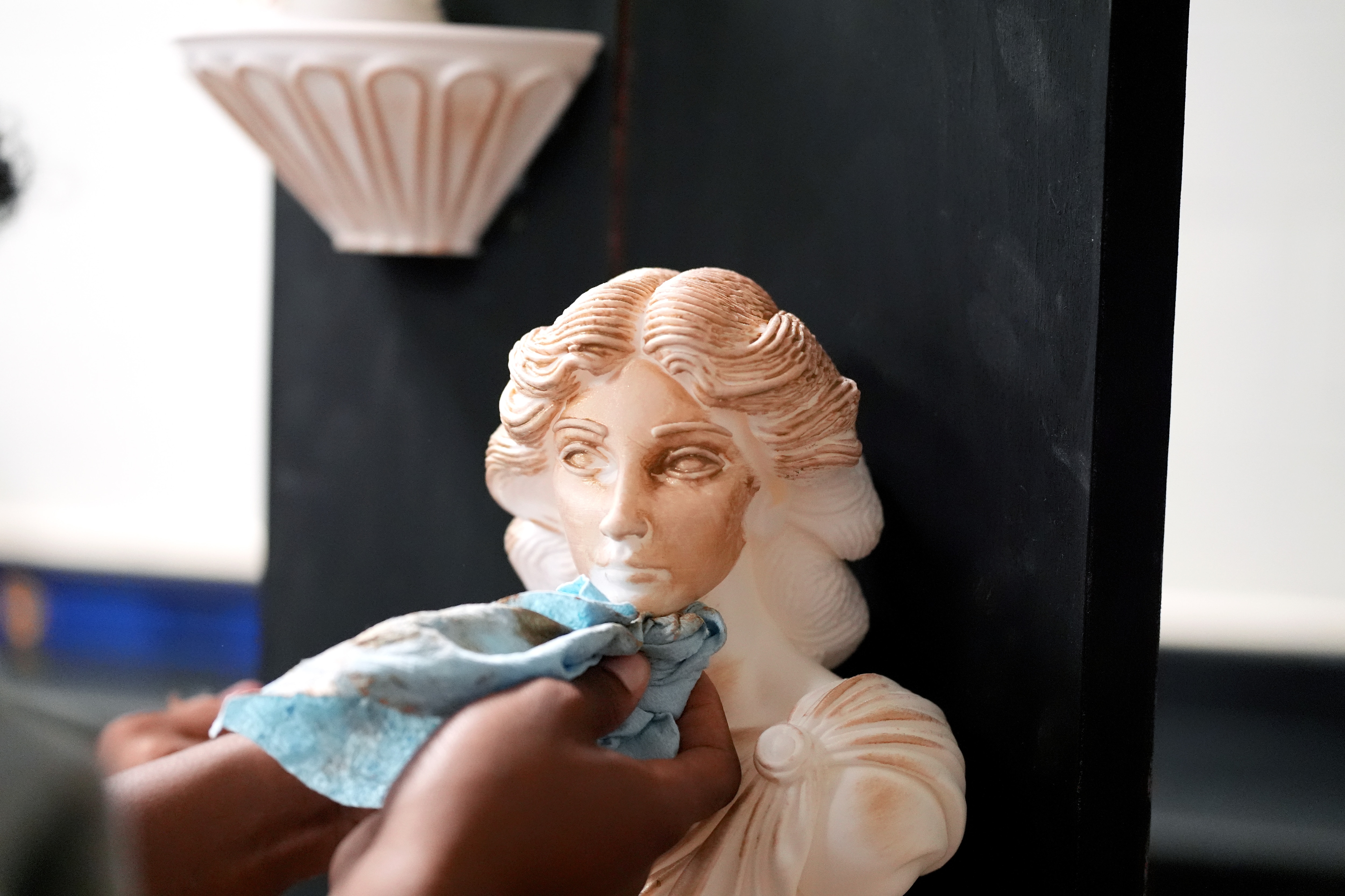 A Haywood High School student gently applies paint to a prop figurine, researched, designed and manufactured by students in the Career and Technical Education (CTE) program in Brownsville, Tenn., using 3D printers in order to make the prop figurines of an upcoming student play based on the Disney movie “Frozen,” in the school’s Ford Future Builders Lab, April 14, 2026. The lab is one of several that opened this academic year in West Tennessee to assist K-12 students and their teachers to learn about tools of skilled trades, including laser cutting, 3D printing and coding. (Rogelio V. Solis for Ford Communications)